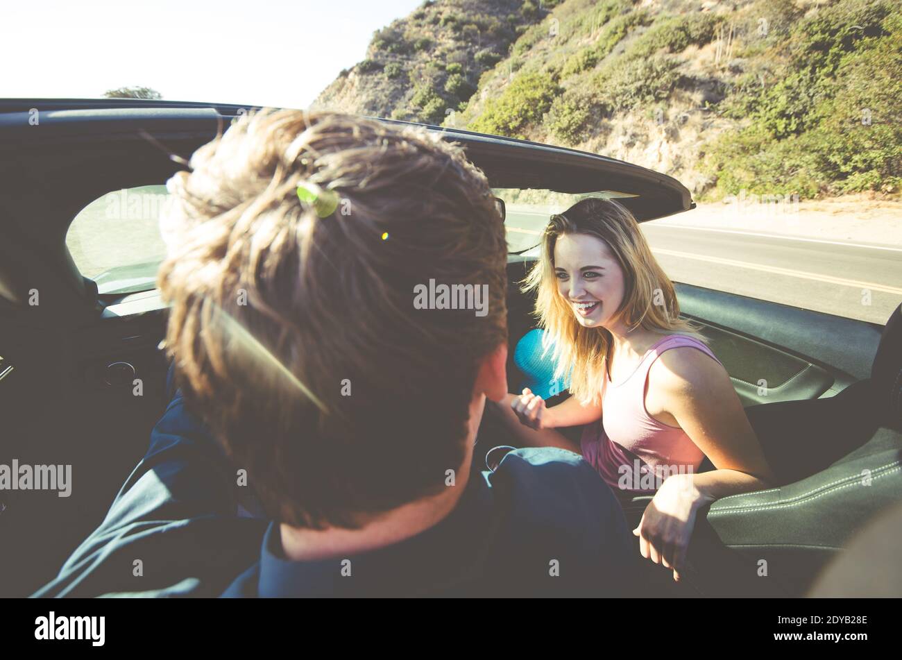 Rear View Of Couple Sitting In Car Stock Photo