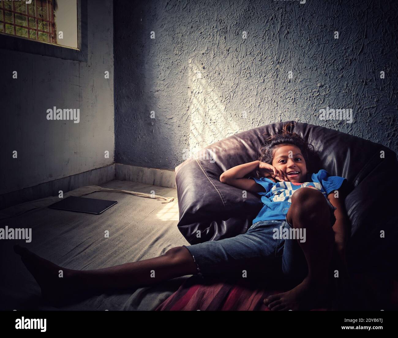 A Cute Girl Laying On Bean Bag Stock Photo Alamy
