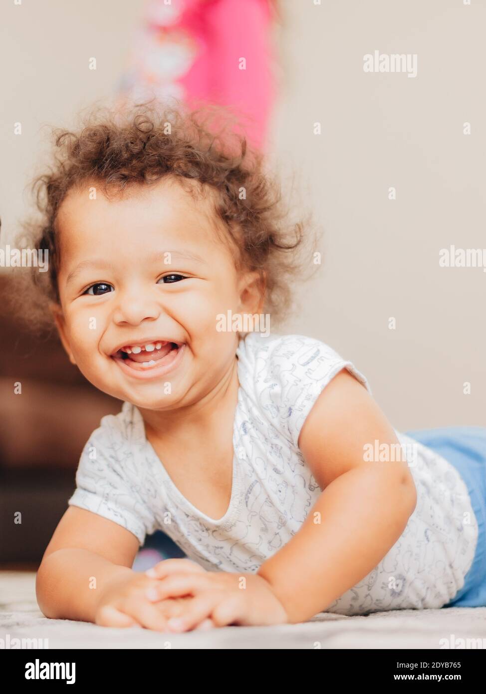Outdoors portrait of cute happy toddler mixed race girl wearing a pink  coat,warm protective boots and leggings Stock Photo - Alamy