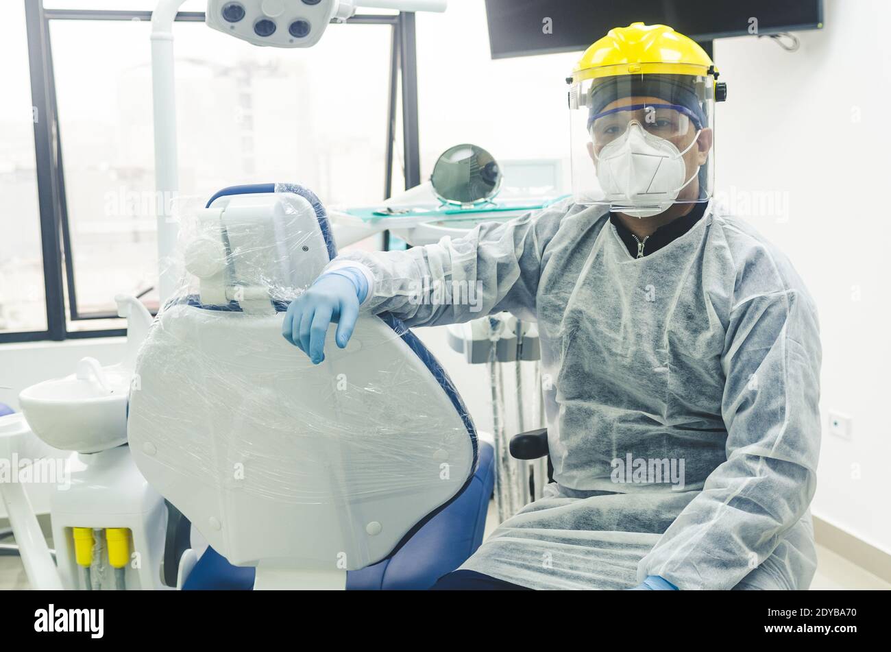 Portrait Of Dentist Wearing Mask And Face Shield Sitting At Clinic Stock Photo Alamy