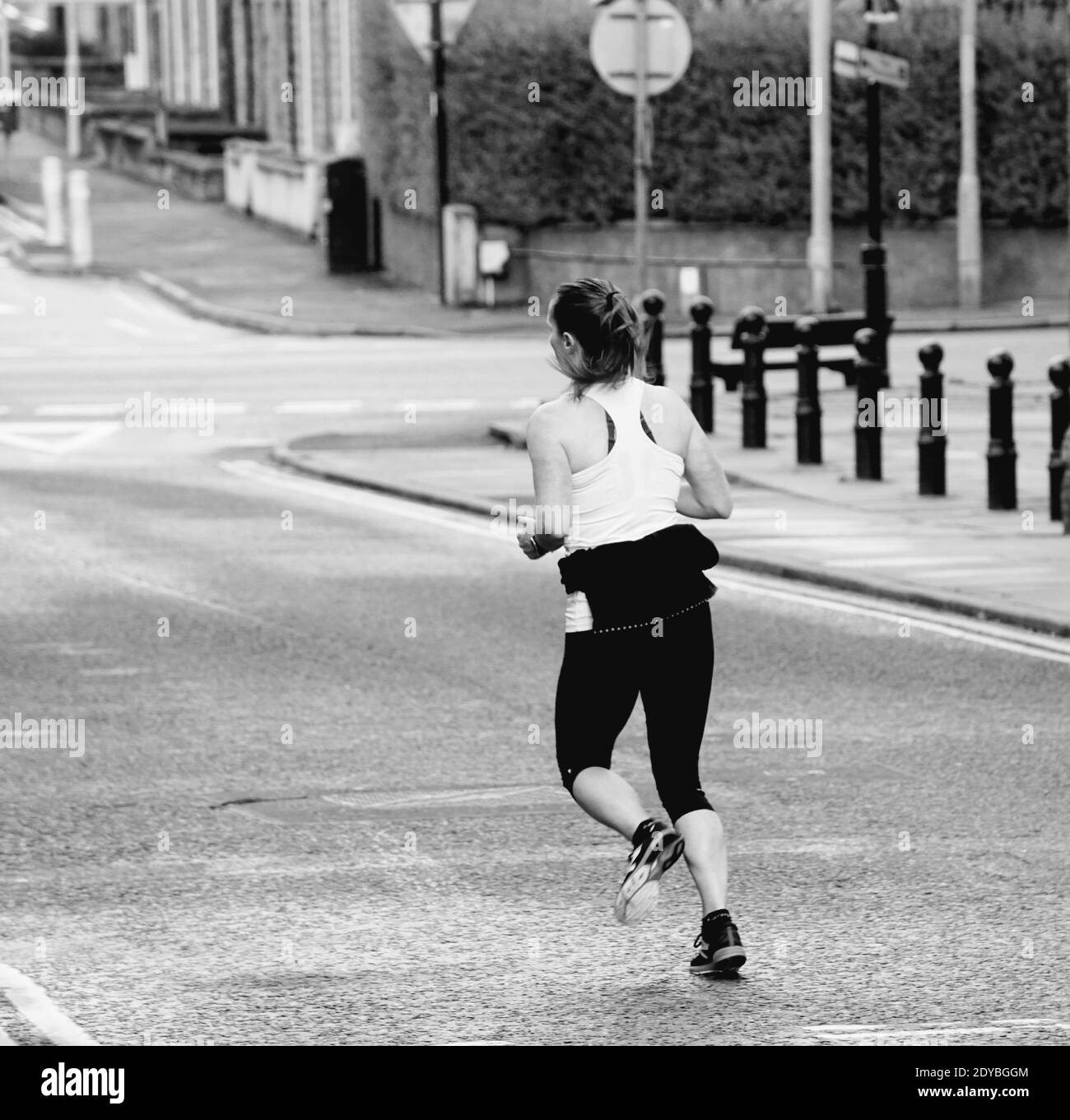 Black woman running rear view Black and White Stock Photos & Images - Alamy
