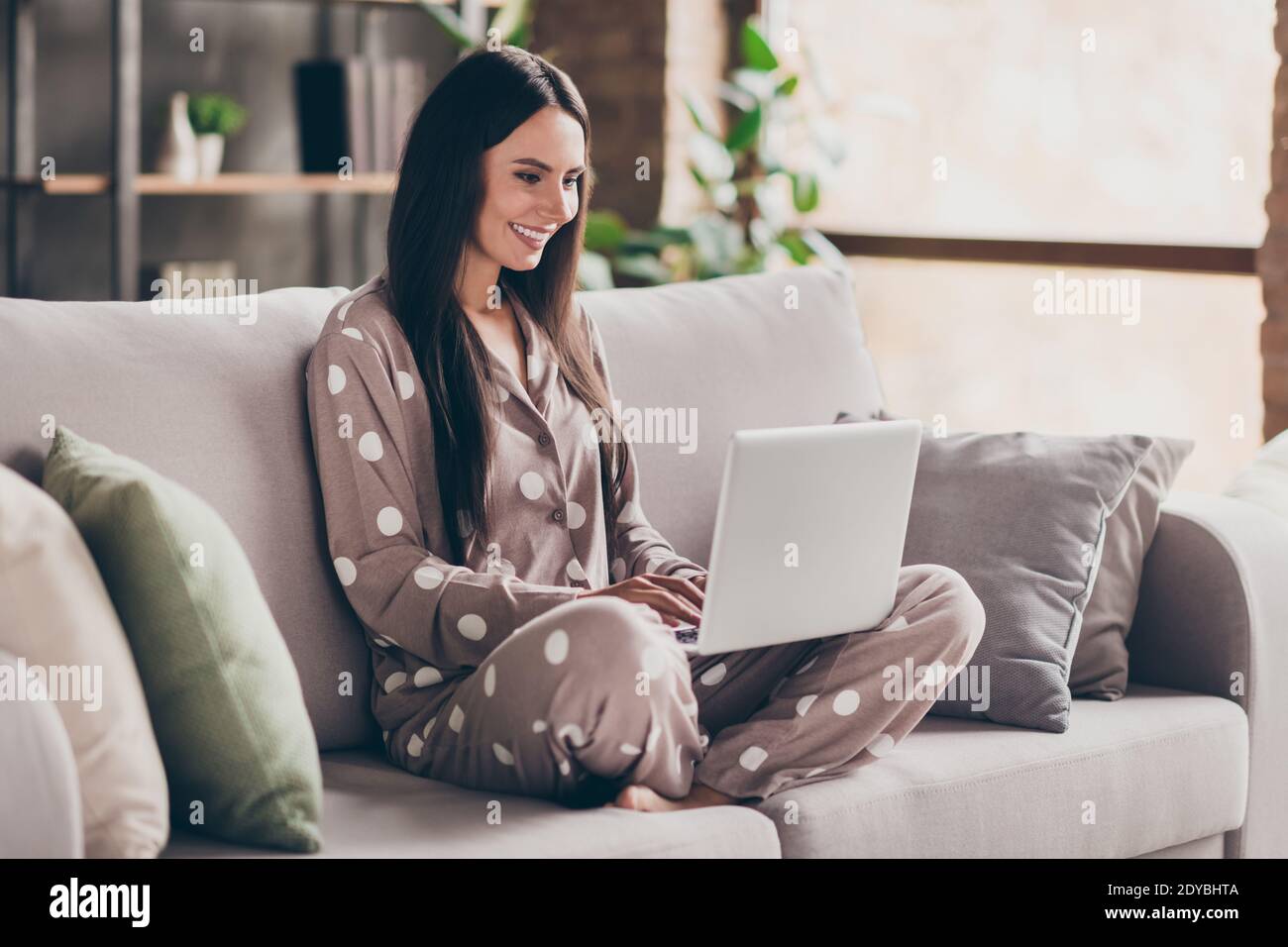 Photo of nice optimistic girl sit with laptop wear pijama at home Stock Photo