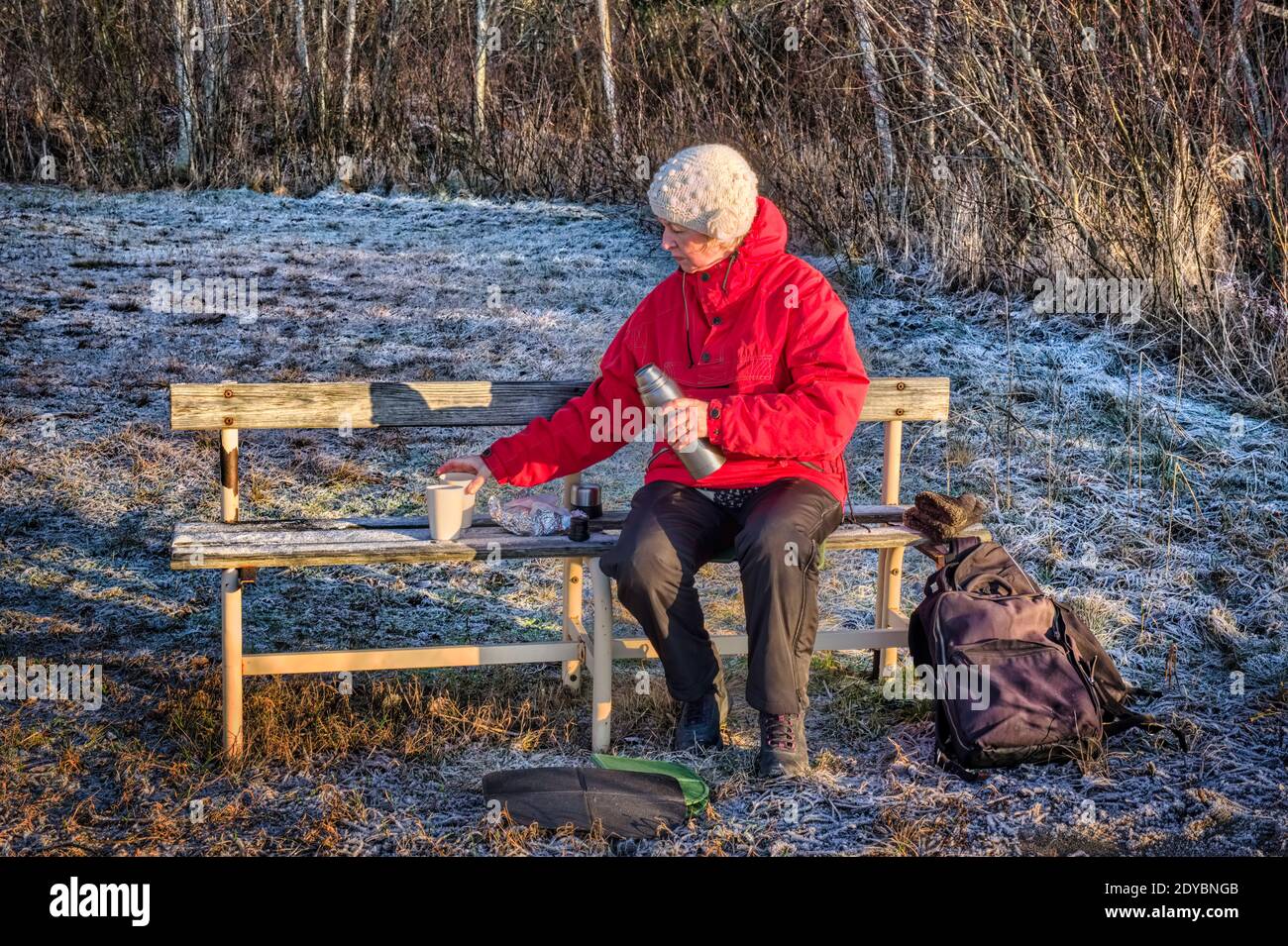 Woman having a coffe break ooutdoors on a chilly winters day Stock Photo