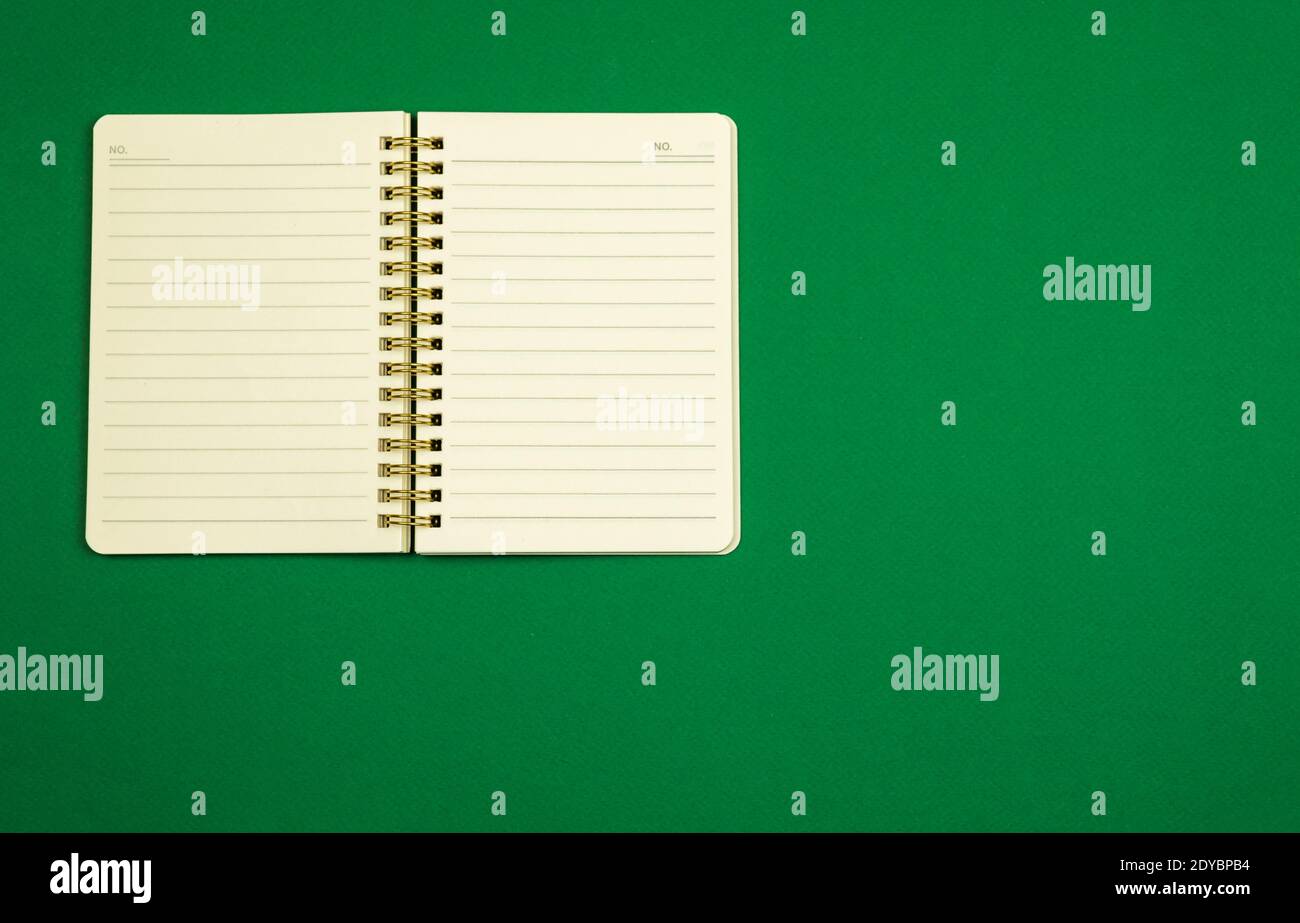 Notepad for notes on a simple green background, flat design, top view