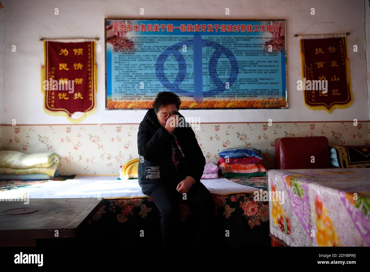 (201225) -- YINCHUAN, Dec. 25, 2020 (Xinhua) -- Ding Haiyan has an emotional moment while recalling the difficult times she had over the six years since she transferred to Hejiayuan Village of Xihaigu in northwest China's Ningxia Hui Autonomous Region, Oct. 28, 2020. Xihaigu, a largely mountainous region in northwest Ningxia, was once inflicted by deep poverty and labeled the 'most unfit place for human settlement' by the United Nations in the 1970s due to land reclamation, drought, and a fragile ecological environment. On Nov. 16, 2020, Xihaigu historically bid farewell to absolute poverty, d Stock Photo