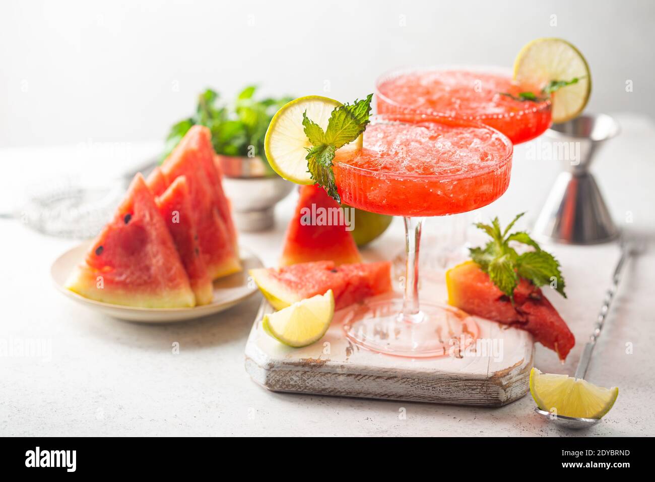 Watermelon frozen cocktail margarita with fresh watermelon, lime and mint on white background Stock Photo