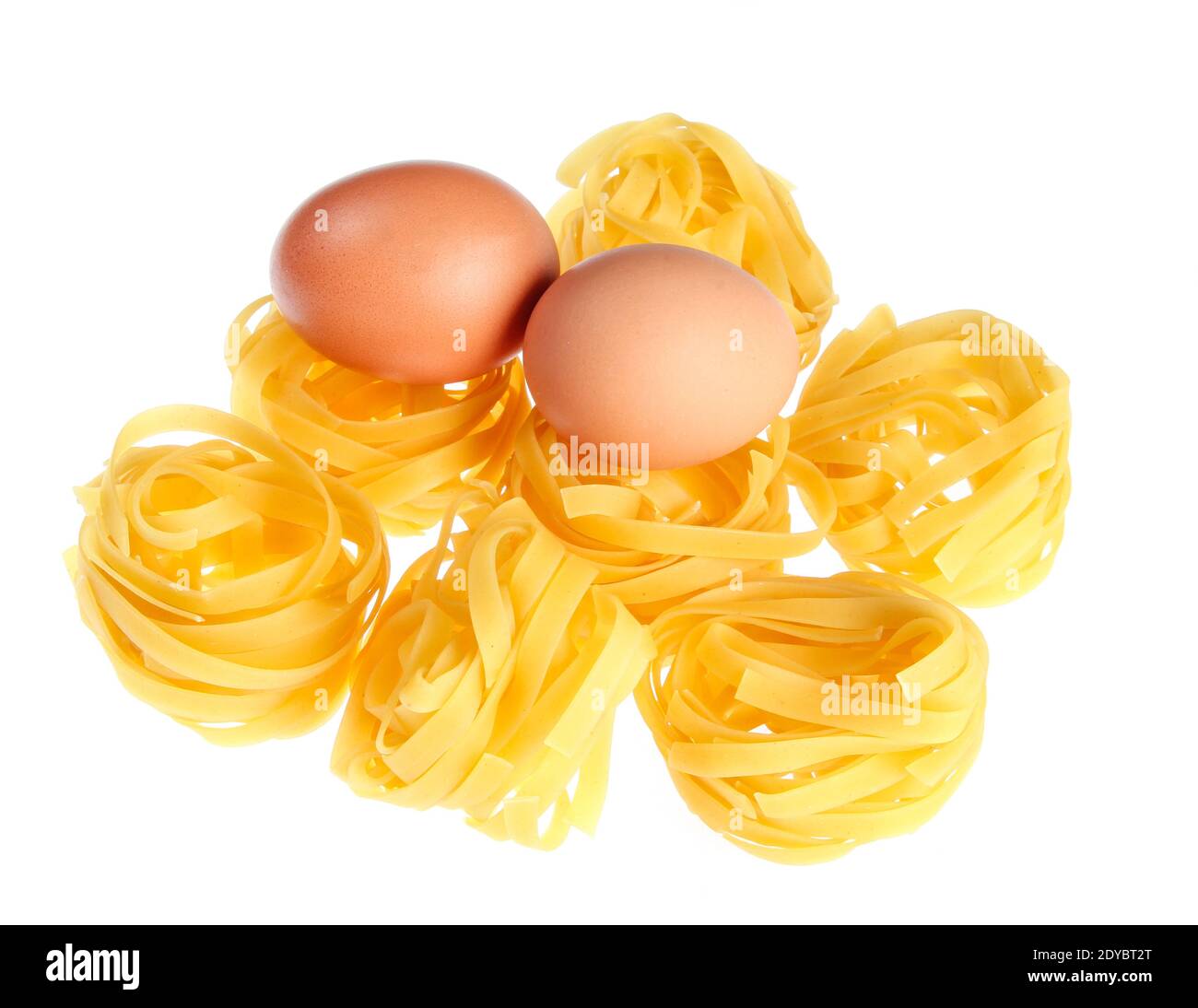 Raw dry tagliatelle noodle, eggs close up isolated on white background