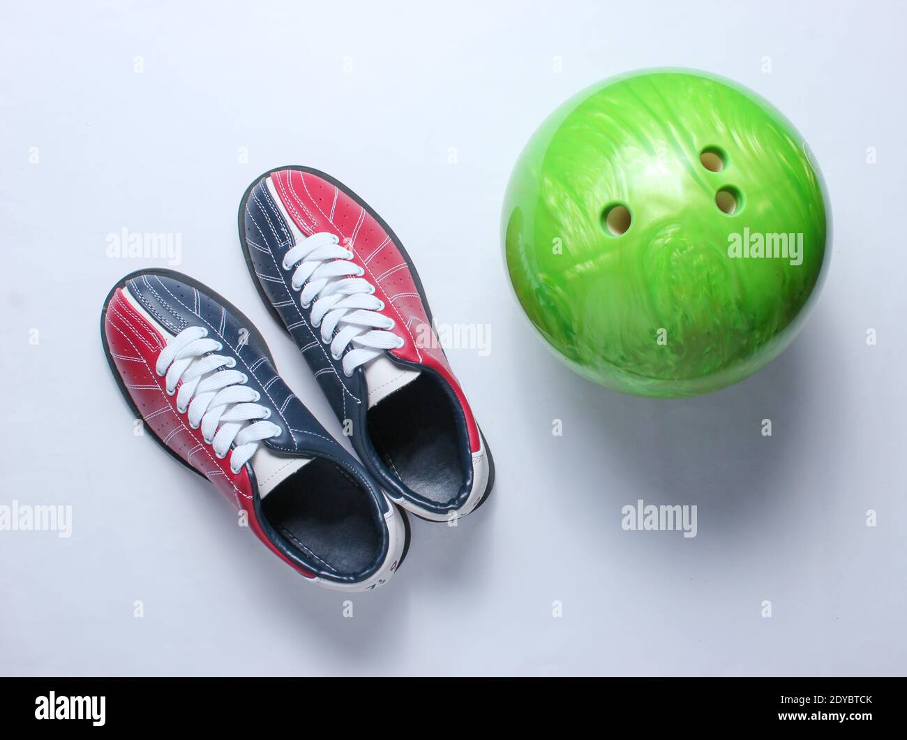 Bowling shoes and bowling ball on white background. Indoor family sports. Top view. Minimalism Stock Photo