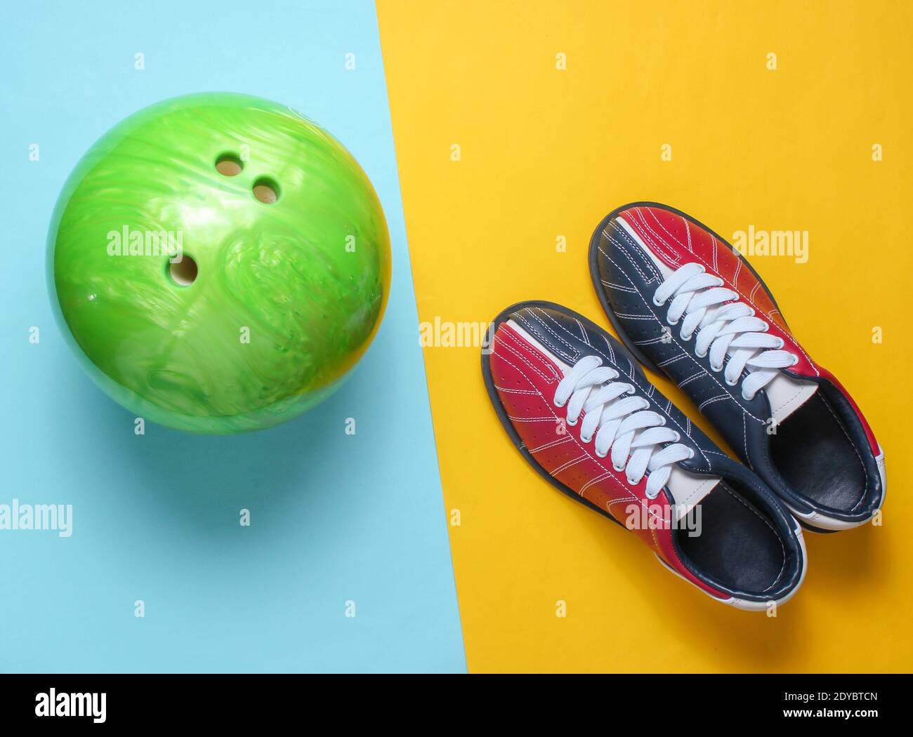 Bowling shoes and bowling ball on blue yellow background. Indoor family sports. Top view