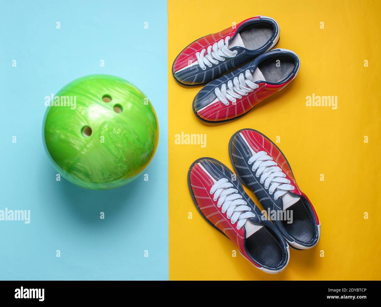 Bowling shoes and bowling ball on blue yellow background. Indoor family