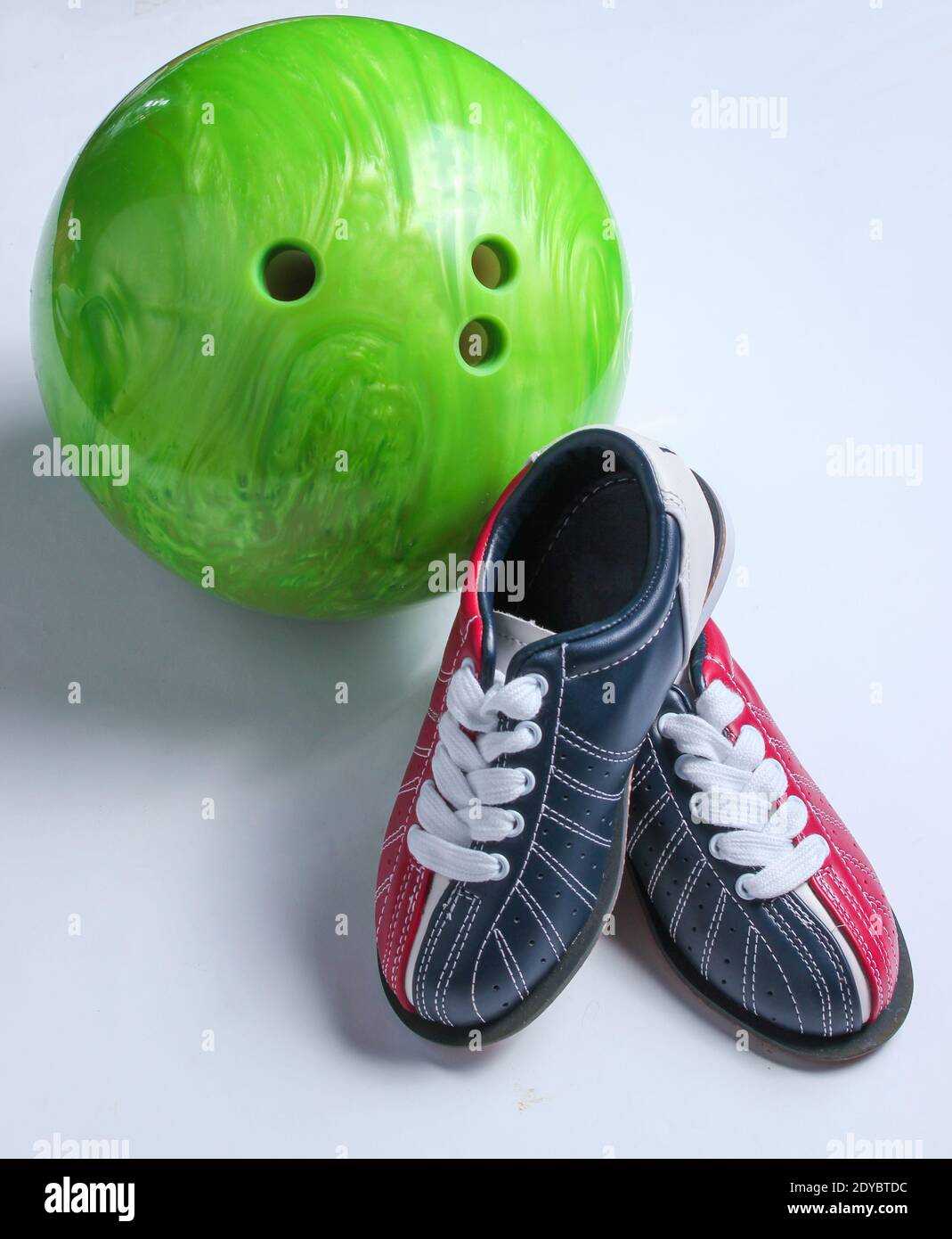 Bowling shoes and bowling ball on white background. Indoor family sports. Minimalism Stock Photo