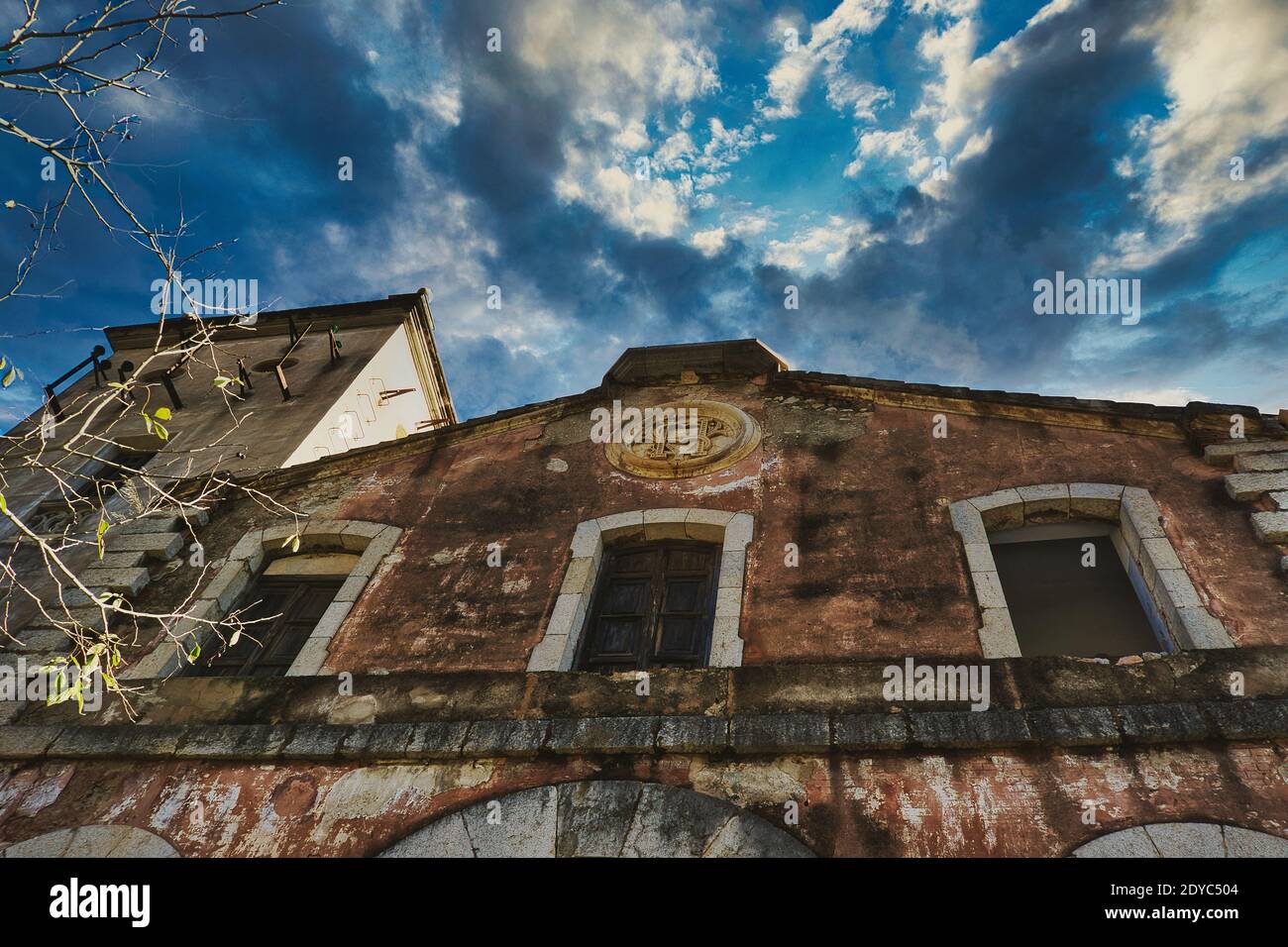 abandoned factory with dramatic cloud sky in spain Stock Photo