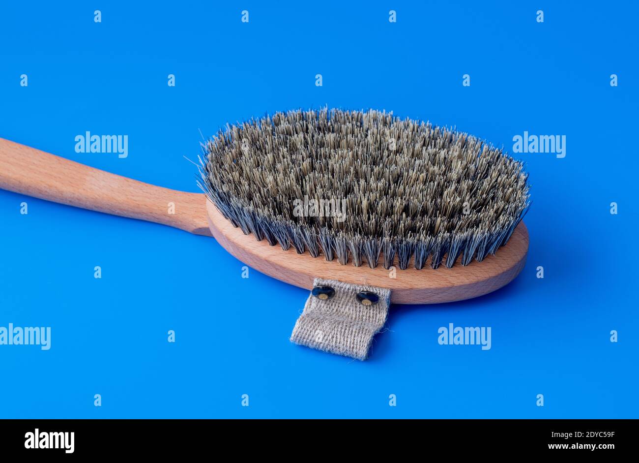 Massage brush with the natural boar bristles on a blue background Stock Photo