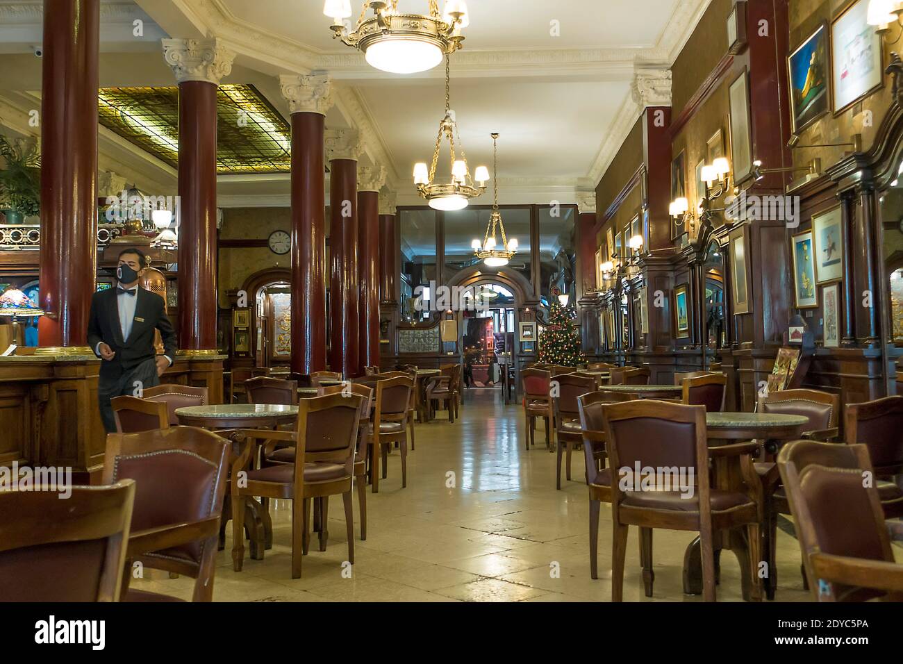 A waiter with face mask in the iconic Cafe Tortoni, Buenos Aires, Argentina during the Covid-19 pandemic Stock Photo