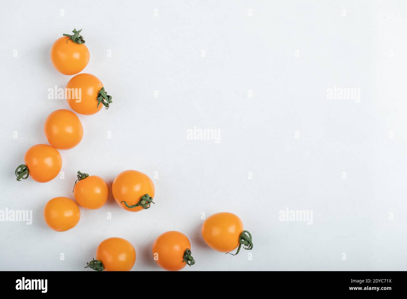 Pile of cherry tomatoes on white background Stock Photo - Alamy