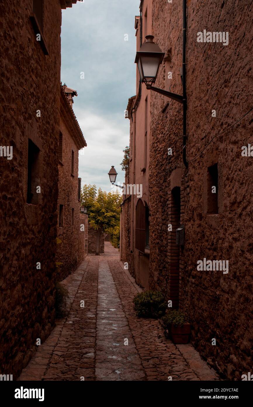 A vertical shot of a narrow street between the stone buildings Stock ...