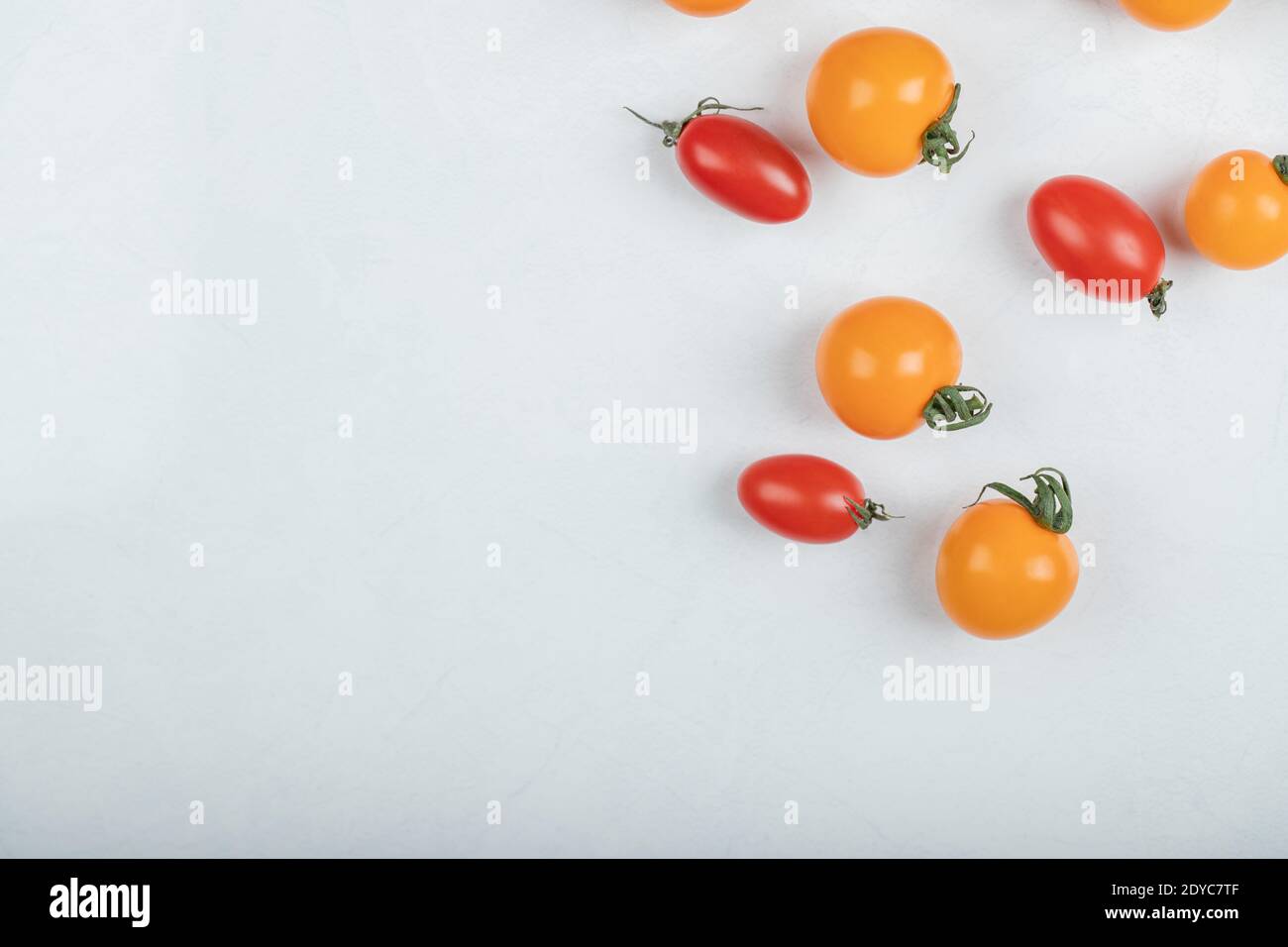 Fresh organic red and yellow tomatoes on white background Stock Photo ...