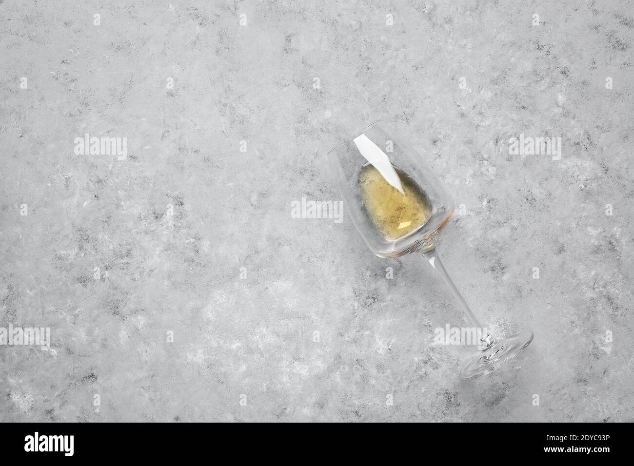Flat lay glass with white wine on gray grunge background. Top view Stock Photo
