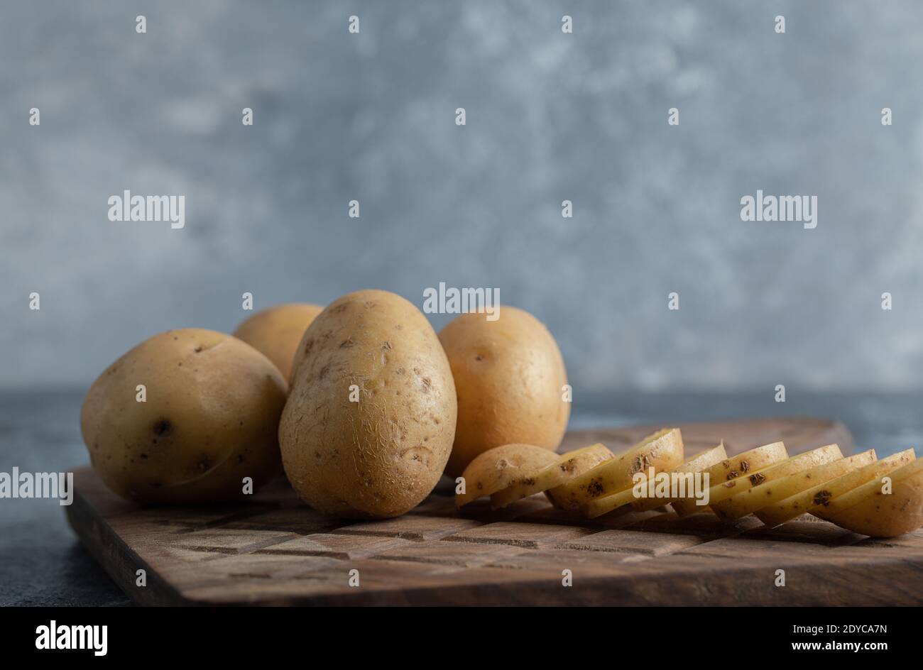 Close up photo of sliced and whole potatoes Stock Photo
