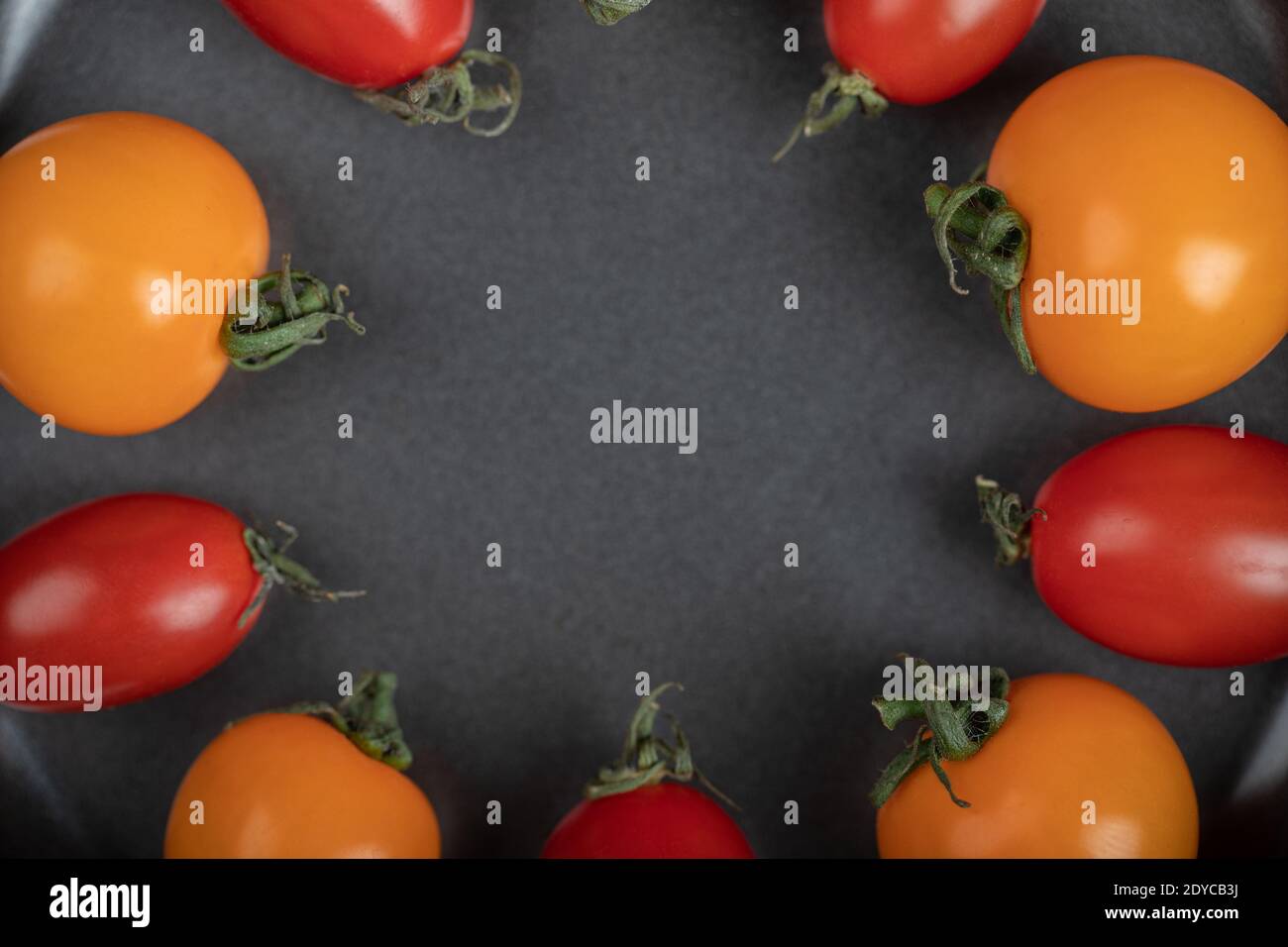 Close up photo of red and yellow cherry tomatoes inside of pan Stock ...