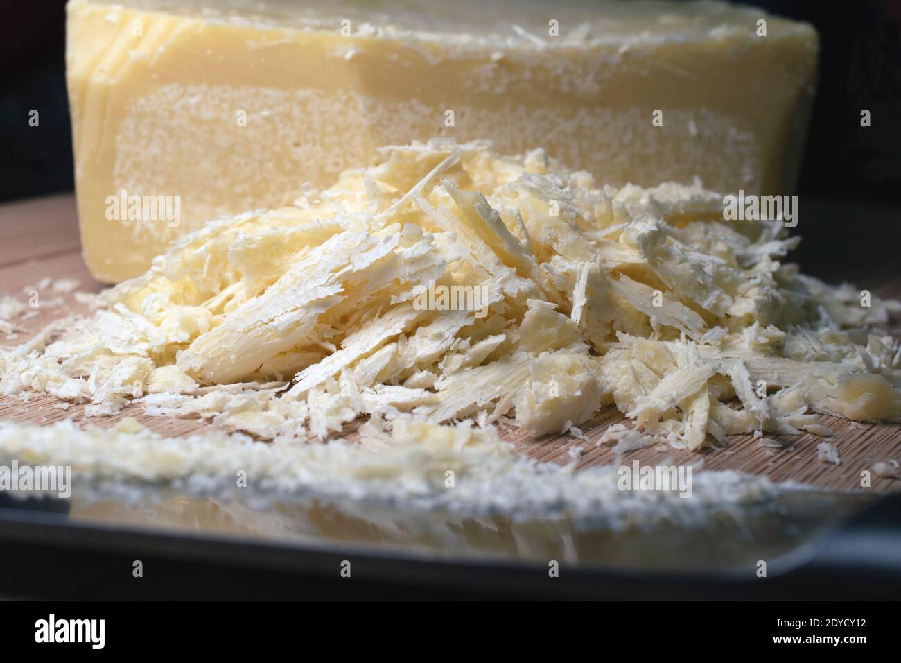 Shreds of cocoa butter carved from a solid cocoa butter block Stock