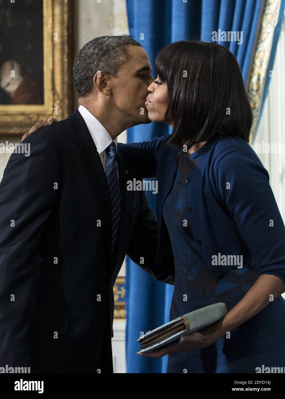 US President Barack Obama kisses US first lady Michelle Obama after being sworn in for a second term as President in the Blue Room of the White House in Washington, DC, USA, on January 20, 2013. Obama was officially sworn in for his second term as the 44th President of the United States during the 57th Presidential Inauguration but will also participate in a ceremonial swearing in on Monday. Photo by Brenda Smialowski/Pool/ABACAPRESS.COM Stock Photo