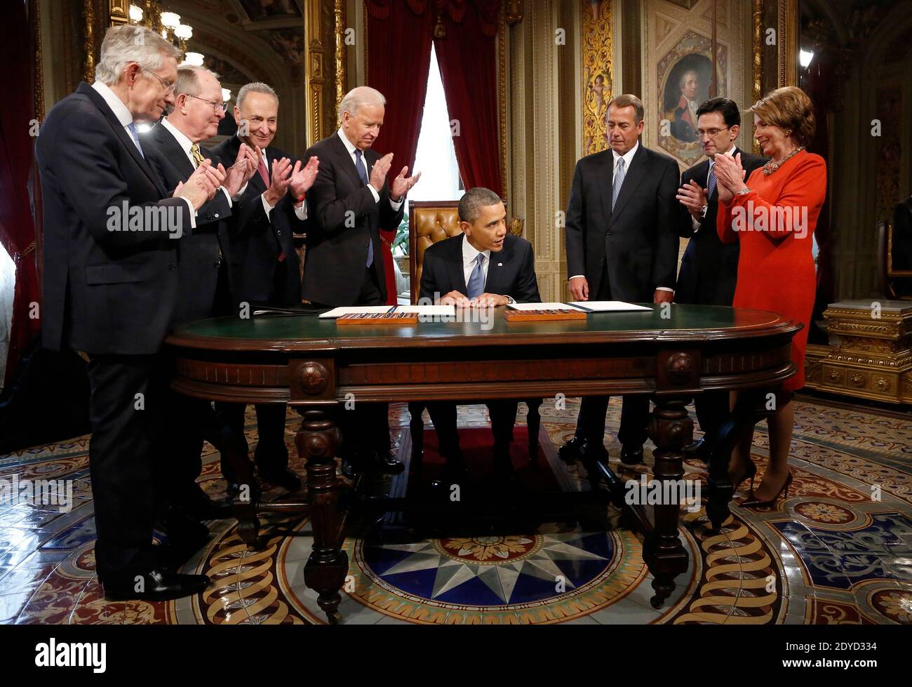 U.S. President Barack Obama (C) is applauded by Senate Majority Leader Harry Reid (D-NV) (L-R), Senator Lamar Alexander (R-TN), Senator Chuck Schumer (D-NY), Vice President Joe Biden, House Speaker John Boehner (R-OH), House Majority Leader Eric Cantor (R-VA) and House Minority Leader Nancy Pelosi (D-CA) after signing a proclamation to commeorate the inauguration, entitled a National Day of Hope and Resolve, directly after swearing-in ceremonies in the U.S Capitol in Washington on January 21, 2013. Photo by Jonathan Ernst/Pool/ABACAPRESS.COM Stock Photo