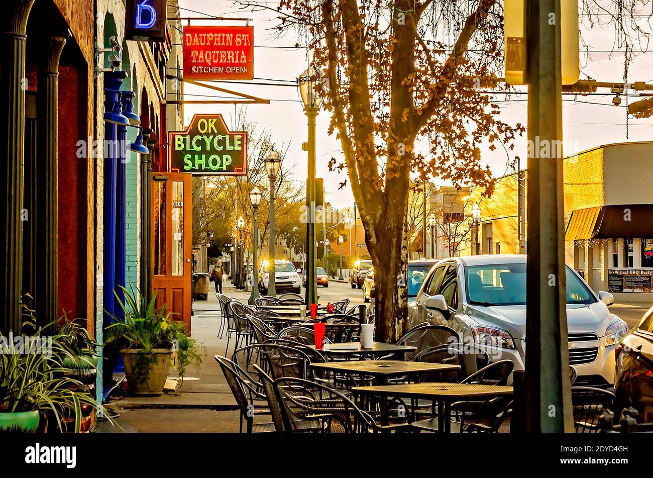 The sun sets on restaurants along Dauphin Street, Jan. 14, 2017, in Mobile,  Alabama. Restaurants include Dauphin St. Taqueria and OK Bicycle Shop Stock  Photo - Alamy