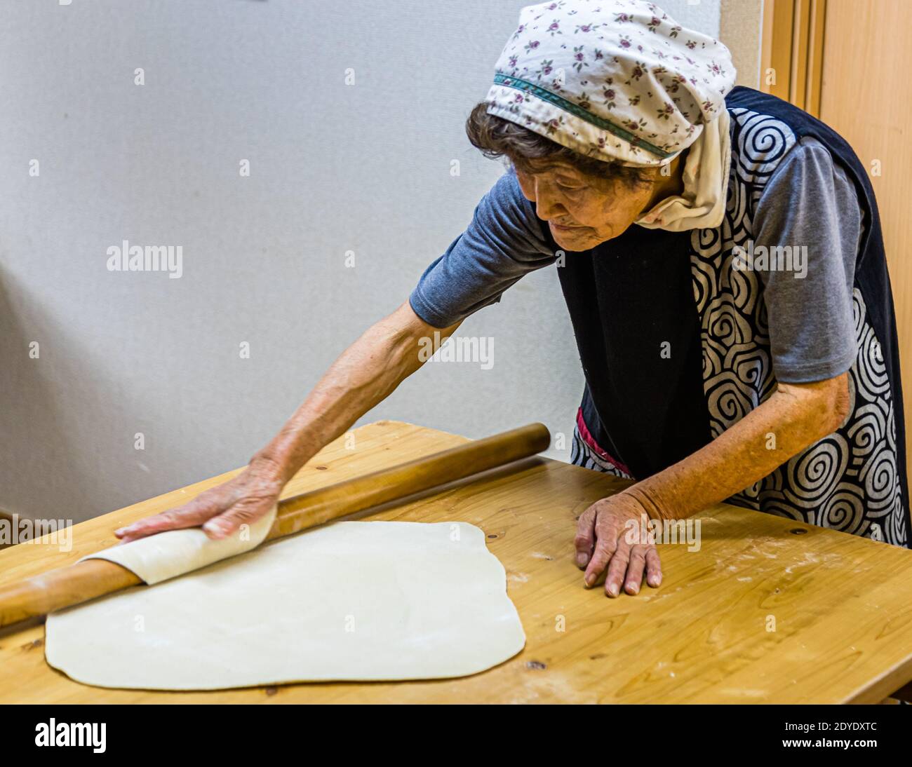 Soba Noodle Preparation in Fujinomiya, Japan. With the long rolling pin, roll out the soba dough into a thin square Stock Photo