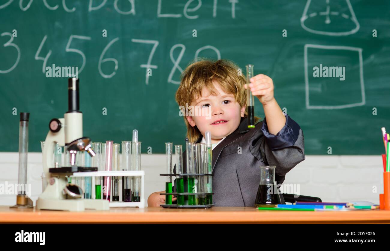 testing tubes with liquid for research. small boy study chemistry ...