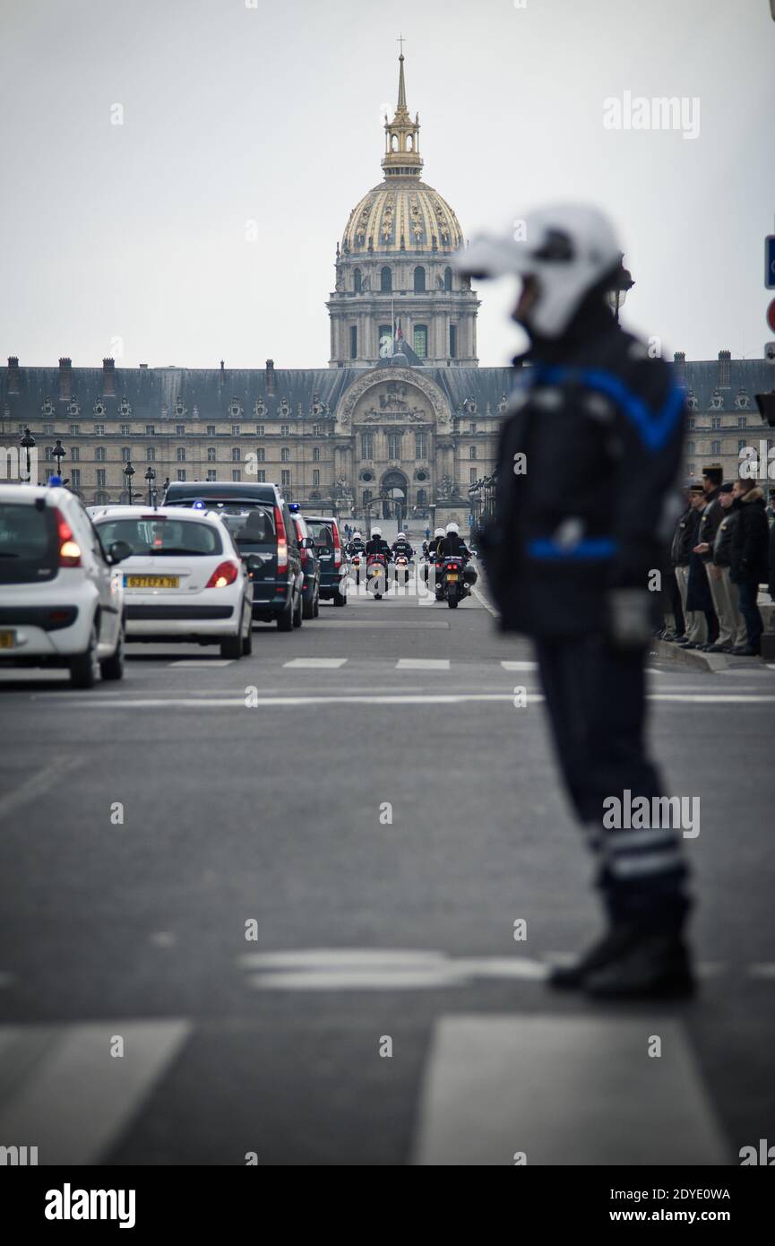 Dozens of people, mostly military personnel and veterans, stand on Alexandre III bridge to pay a tribute to French Staff Sergeant Harold Vormezeele as his coffin passes by, in Paris, France on February 22, 2013. The non-commissioned officer and commando with the 2nd Foreign Parachute Regiment, an elite unit of the French Foreign Legion, was killed whilst serving in Mali. He was the second French soldier killed since the start of France's military intervention in Mali on January 11. A private ceremony will be chaired in the afternoon by the Minister of Defence in the courtyard of the Invalides. Stock Photo