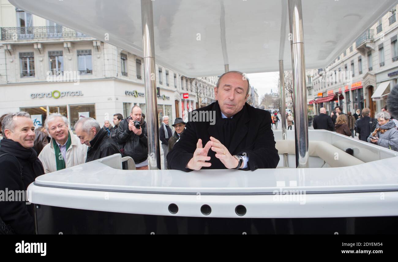 Senator mayor of Lyon Gerard Collomb inaugurates a new robotic shuttle. This innovative robot of 8 places circulates without human intervention. He allows persons' transport in self-government and in complete safety thanks to lasers and sensors loaded into the electrical vehicle which allow him to become localized in his environment, to define a trajectory, to discern obstacles to short-circuit them or stop, and to move by inserting all these data. Lyon, France on March 13,2013. Photo by Vincent Dargent/ABACAPRESS.COM Stock Photo