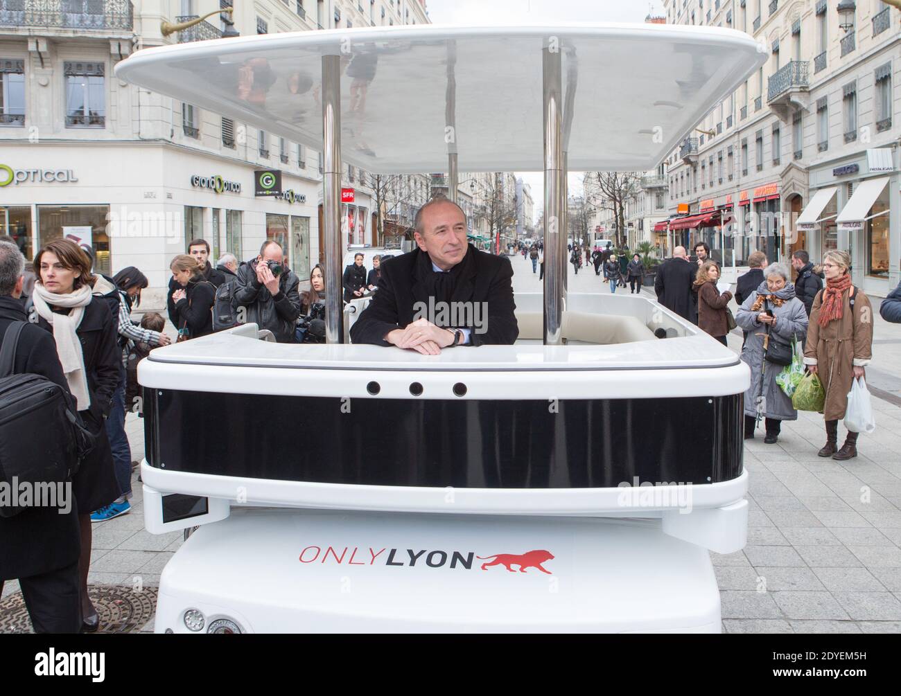 Senator mayor of Lyon Gerard Collomb inaugurates a new robotic shuttle. This innovative robot of 8 places circulates without human intervention. He allows persons' transport in self-government and in complete safety thanks to lasers and sensors loaded into the electrical vehicle which allow him to become localized in his environment, to define a trajectory, to discern obstacles to short-circuit them or stop, and to move by inserting all these data. Lyon, France on March 13,2013. Photo by Vincent Dargent/ABACAPRESS.COM Stock Photo