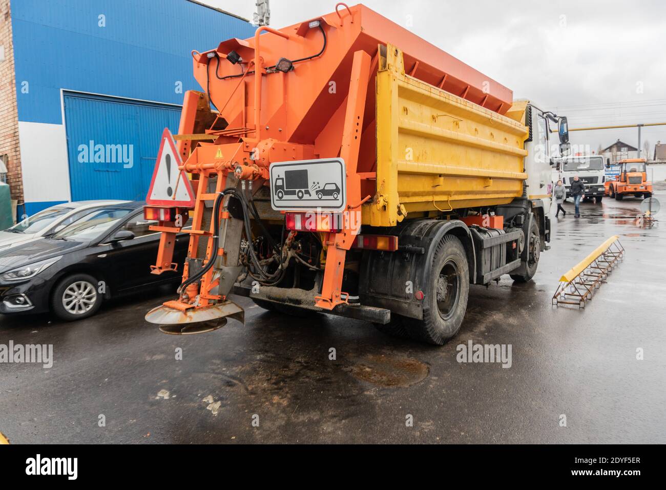 Snow Clearing Machine Using Salt Snow removal equipment sprinkling the road with sand and salt Stock ...