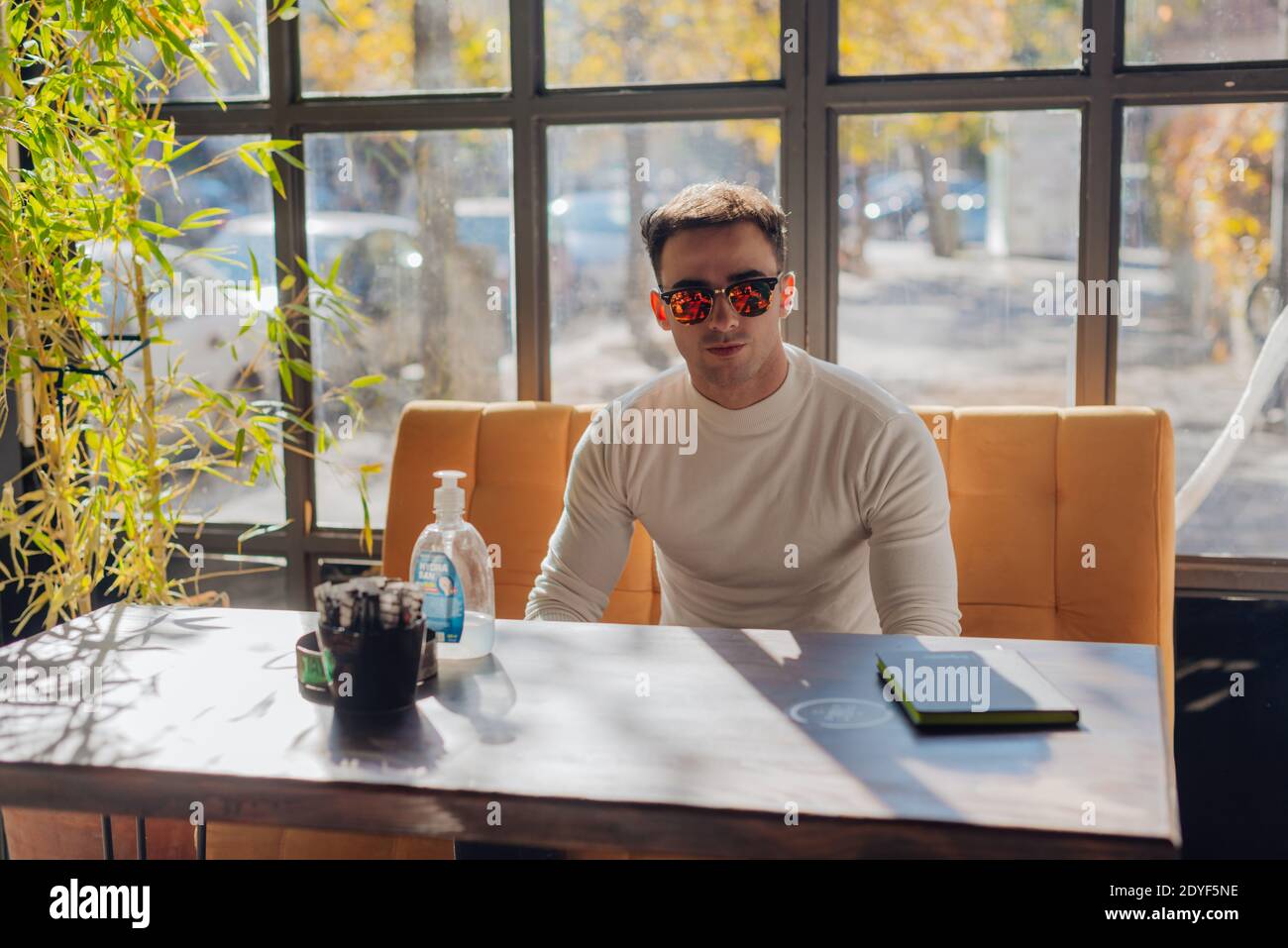 Friends socializing, having fun, and laughing drinking coffee in