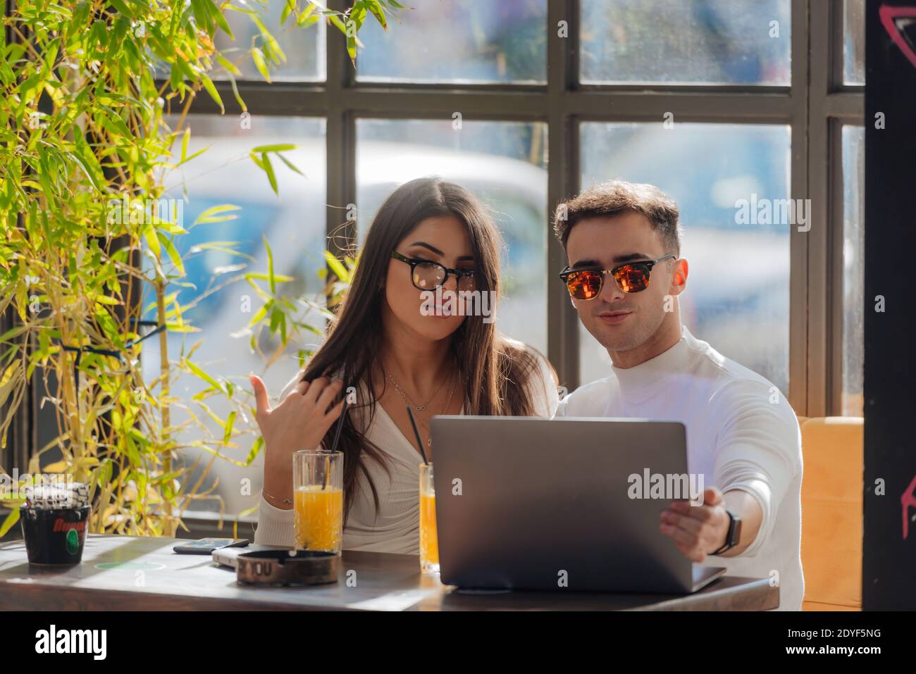 Co-workers spending time together on a break while working on a project on a lovely sunny day. Stock Photo