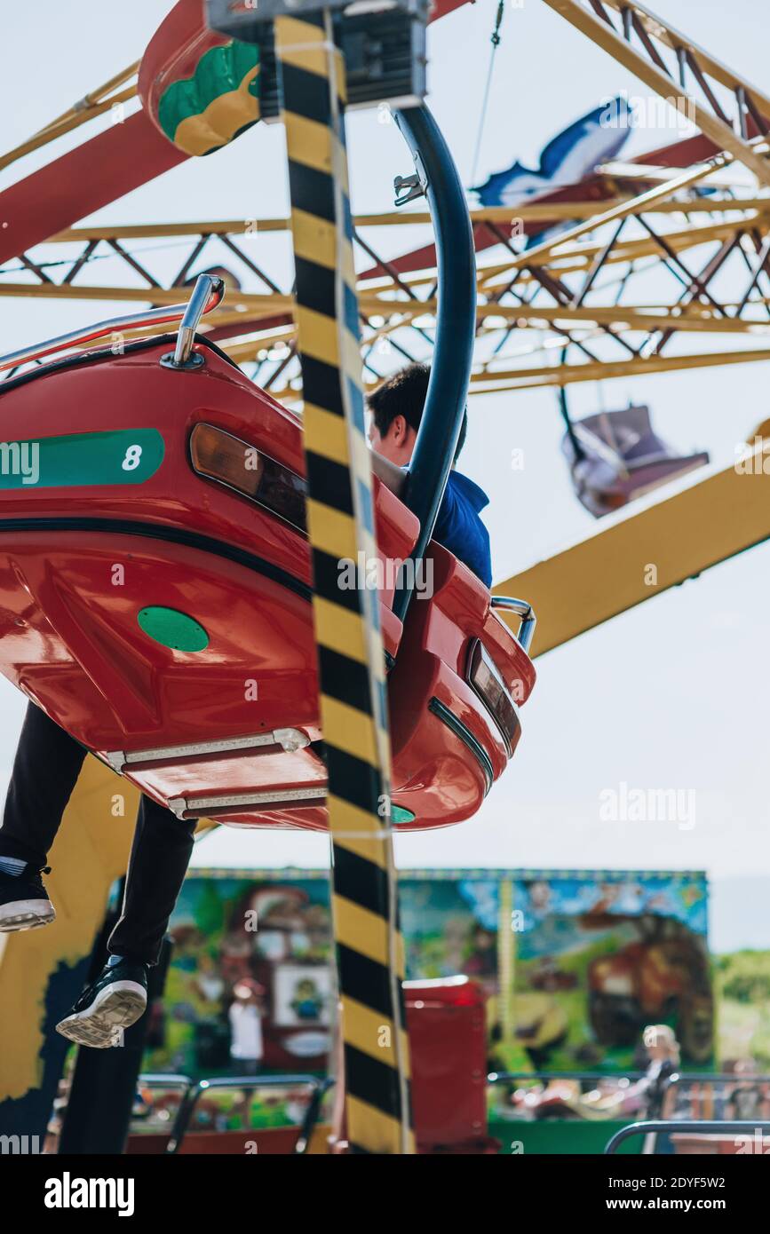 Hanging seats of a swinging carousel fair ride in theme park Stock