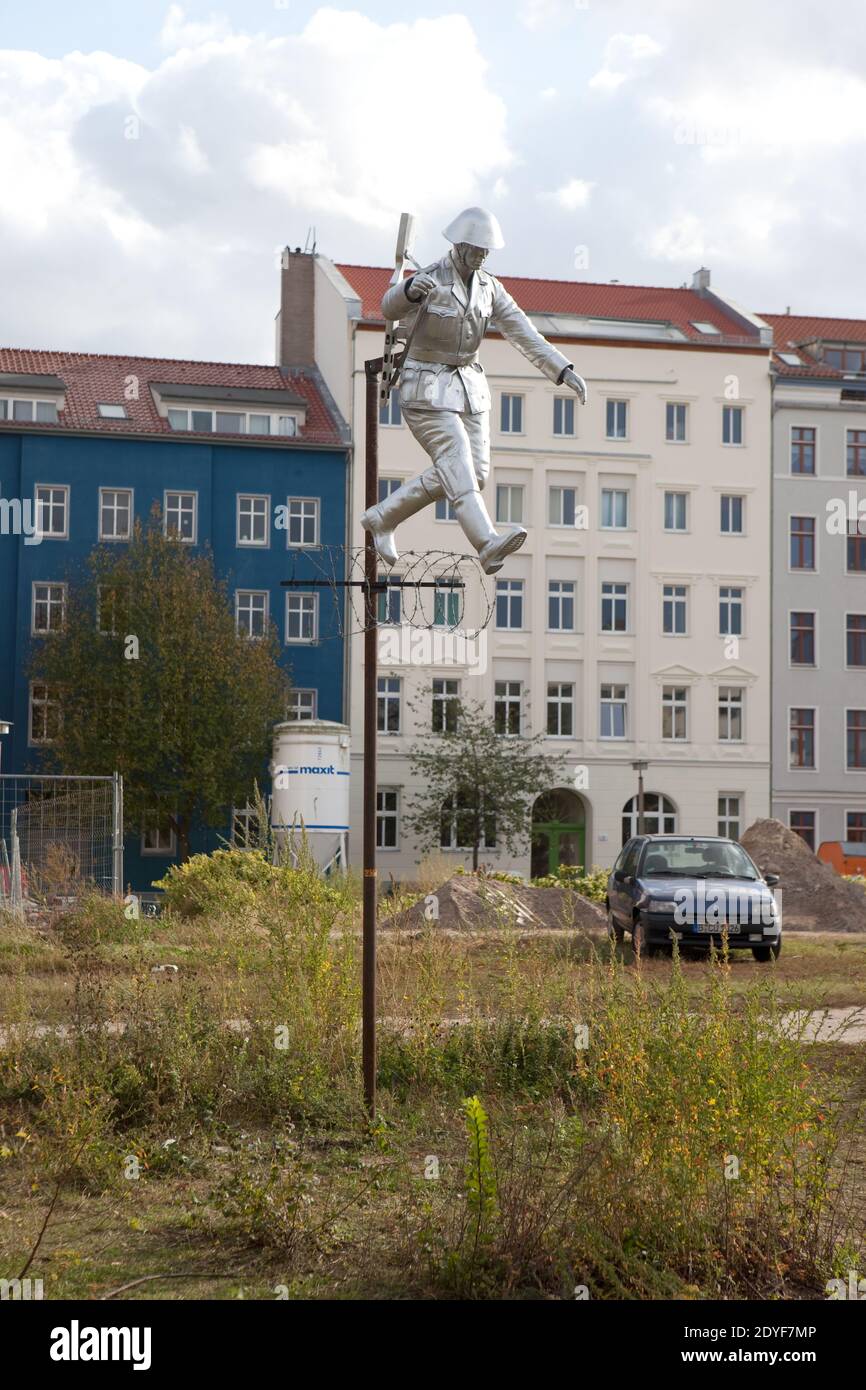 Germany Berlin Sculpture after a famous photograph of East German wall jumping soldier who escaped. Stock Photo