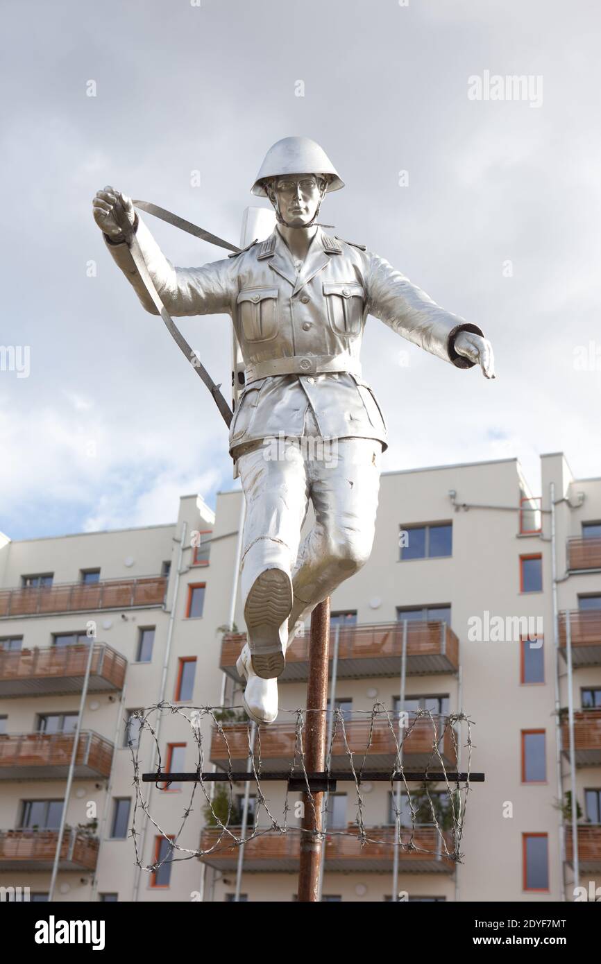 Germany Berlin Sculpture after a famous photograph of East German wall jumping soldier who escaped Stock Photo