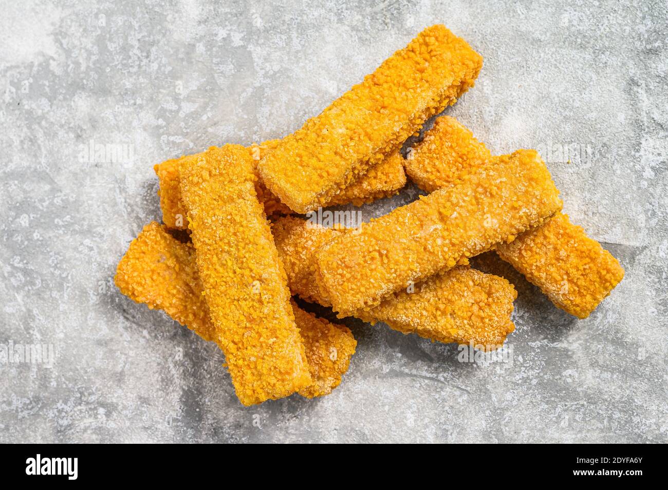 Frozen fish sticks. Organic fish food. Gray background. Top view Stock