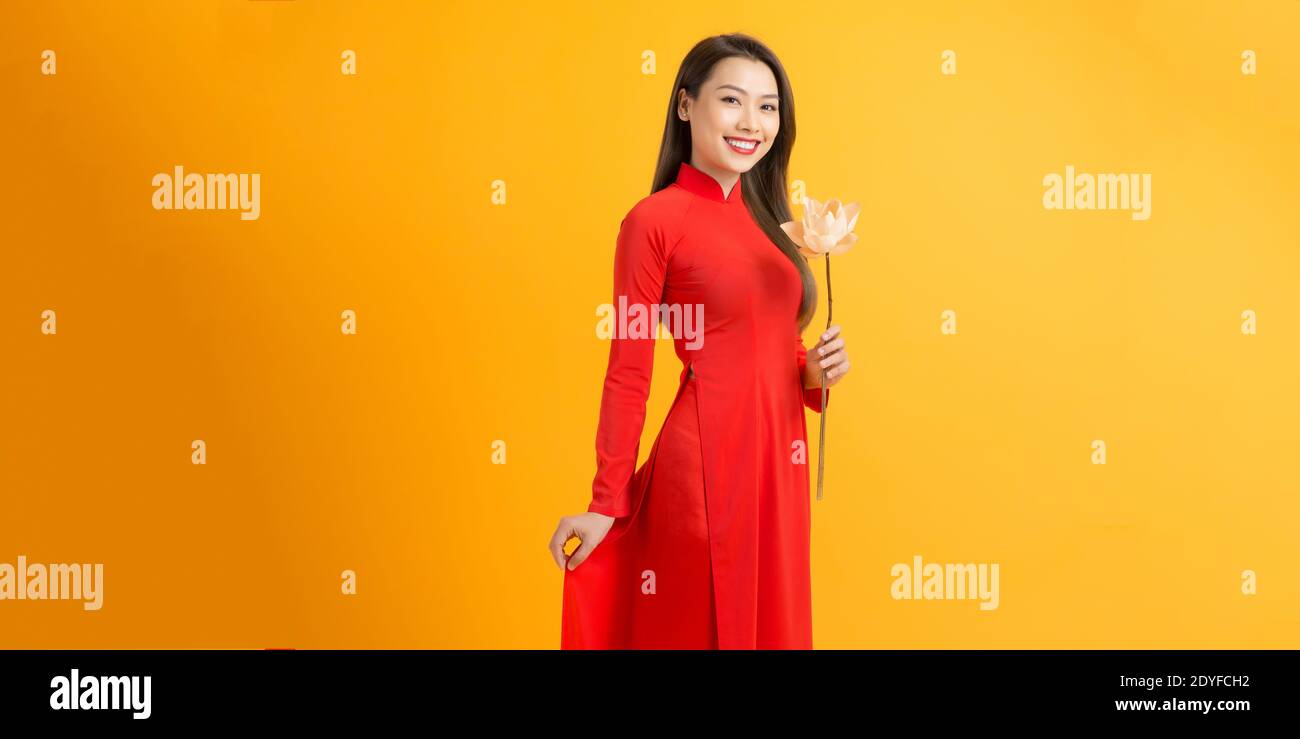 Vietnamese girl holding a lotus flower, The Ao dai ( long-dress Vietnamese) is traditional costume of Vietnamese woman Stock Photo