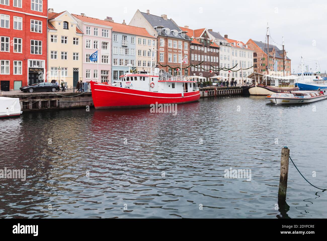 Copenhagen, Denmark - December 10, 2017: Coastal view of Nyhavn or New Harbour, it is a 17th-century waterfront, canal and popular touristic district. Stock Photo