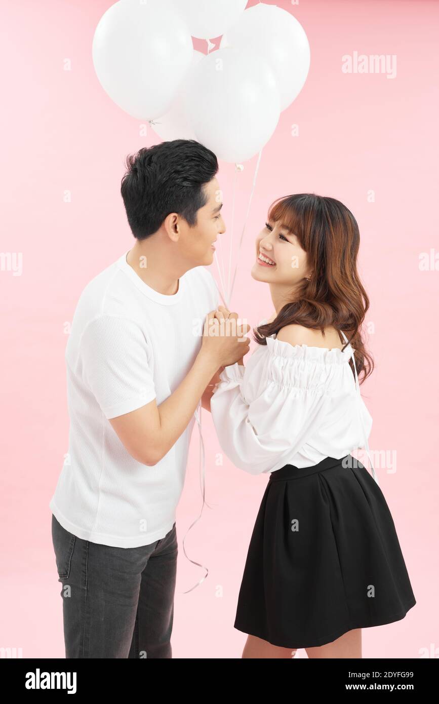 Happy emotions of the couple with the balloons Stock Photo - Alamy