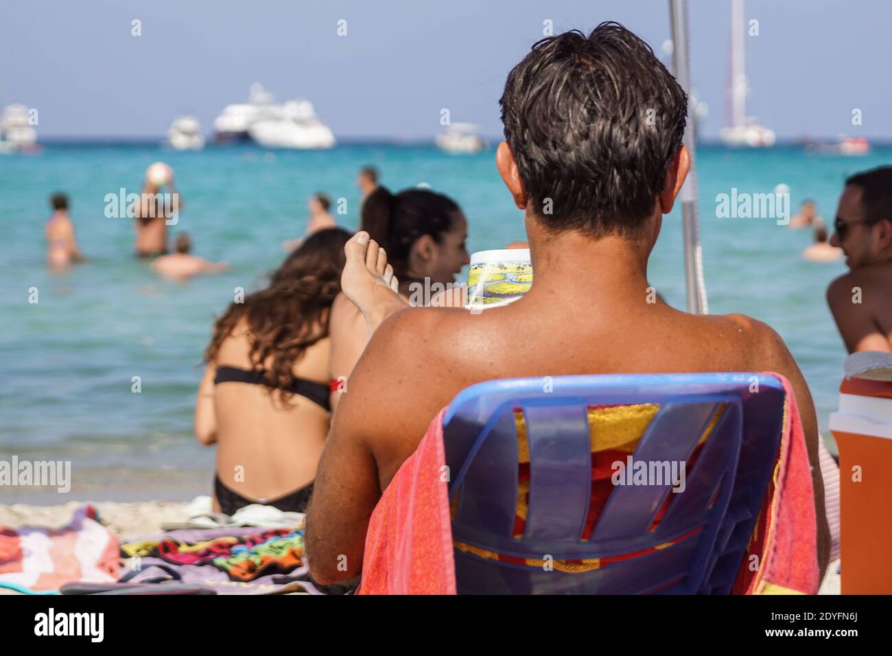 Sardegna , Italy - July 28, 2020 : Unidentified tourists or people they relax by doing leisure activities on the beach in italy Stock Photo