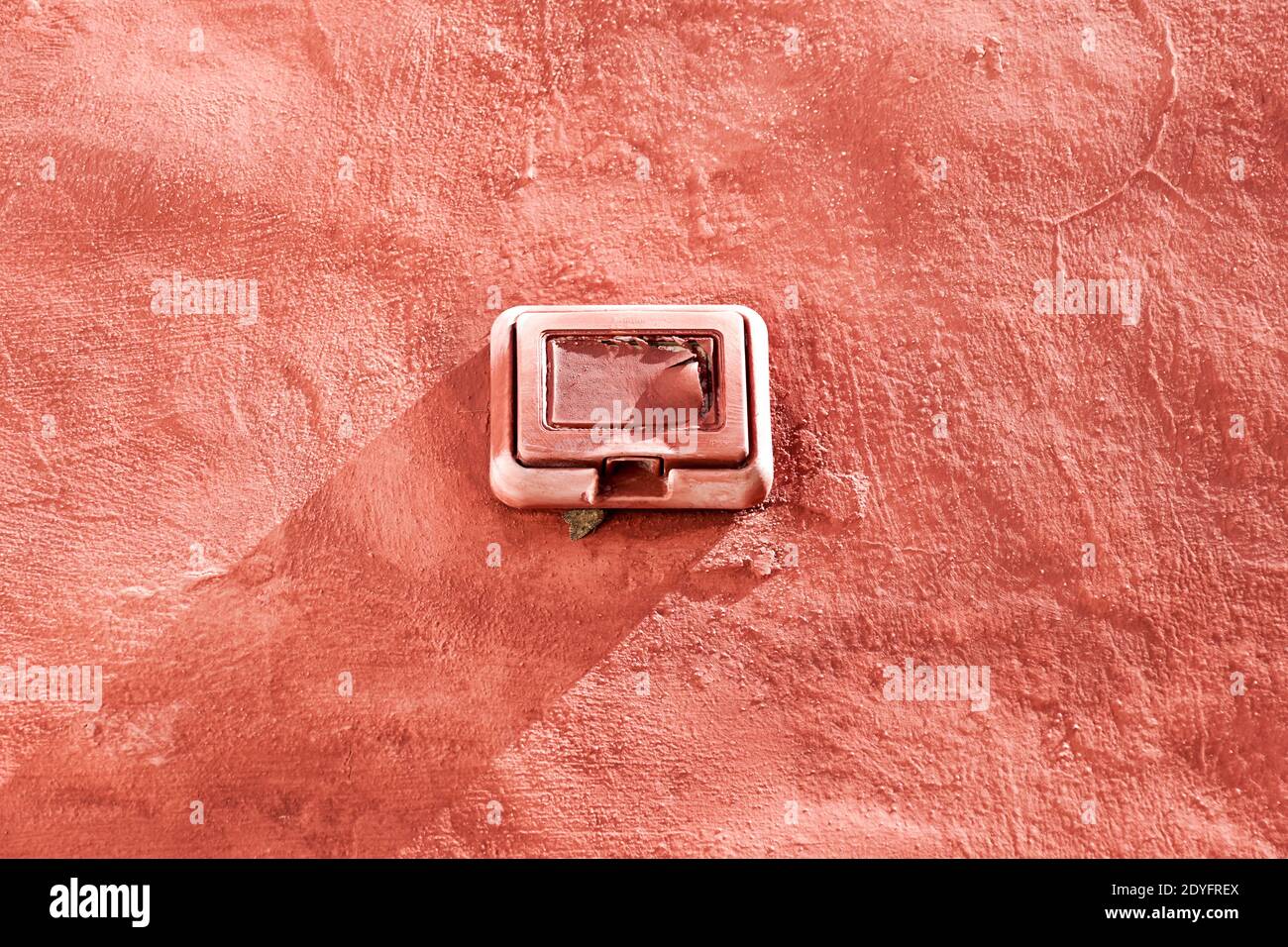 light switch on old red wall . Electric component Stock Photo