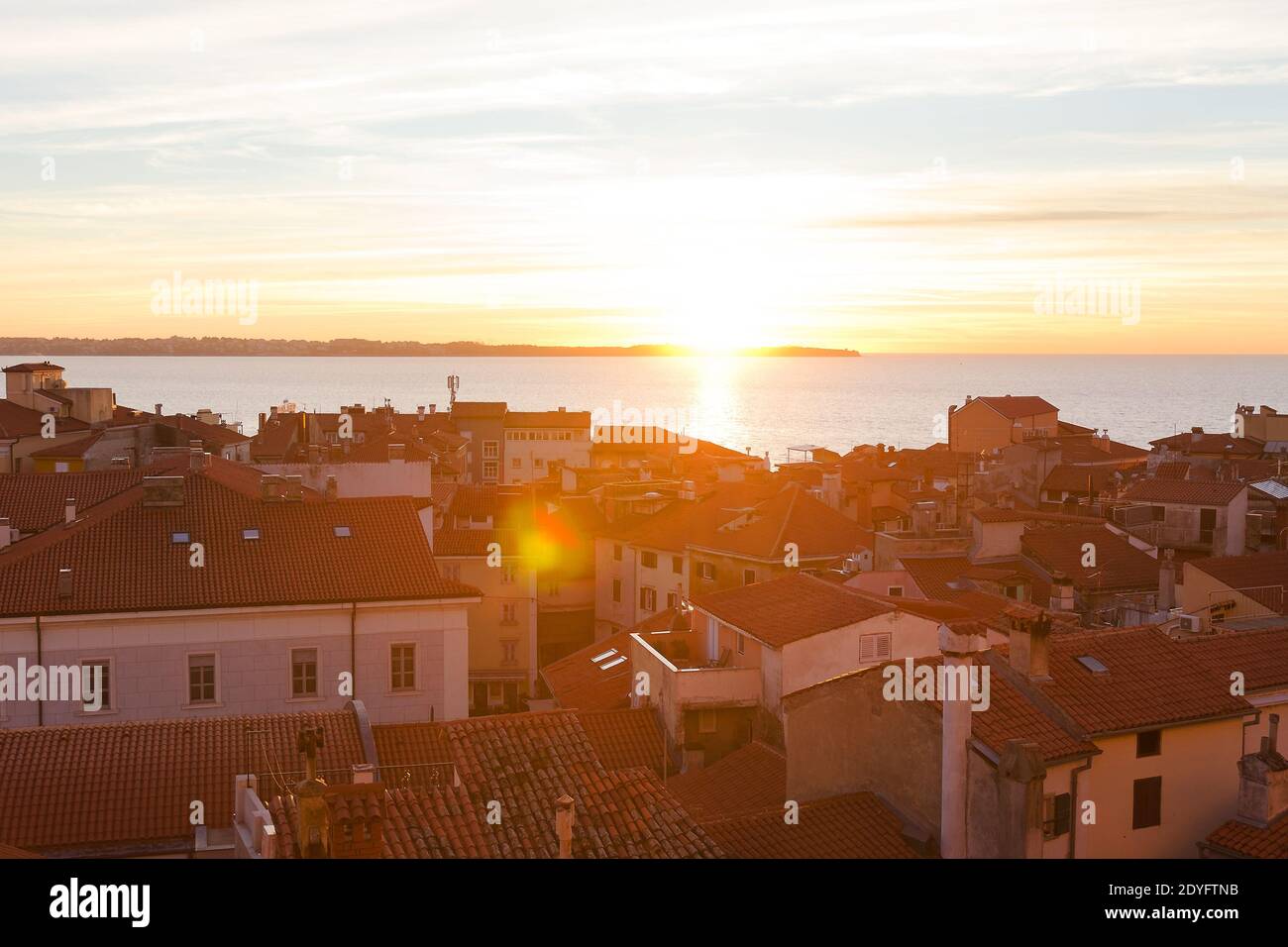 Red roofs of the historical center of old town Piran against the sunset sky and Adriatic sea, aerial view, Slovenia Stock Photo