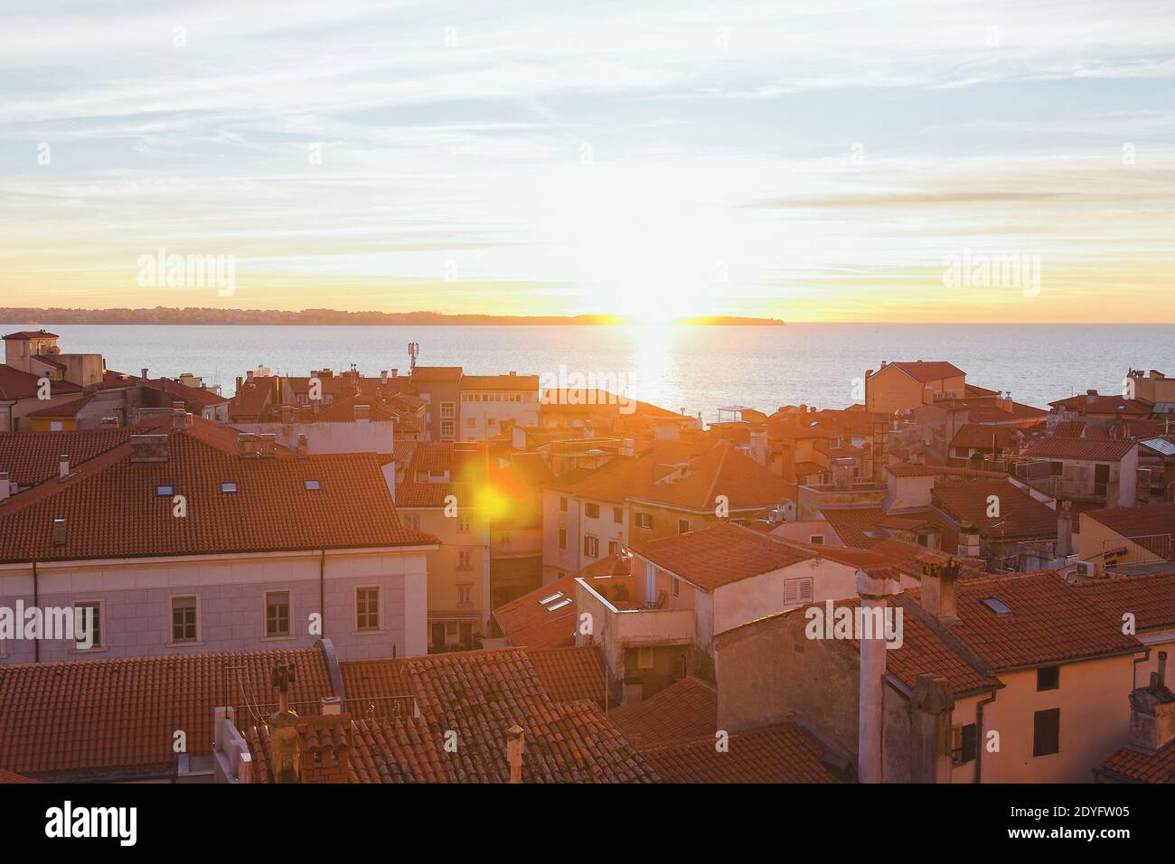 Red roofs of the historical center of old town Piran against the sunset sky and Adriatic sea, aerial view, Slovenia Stock Photo