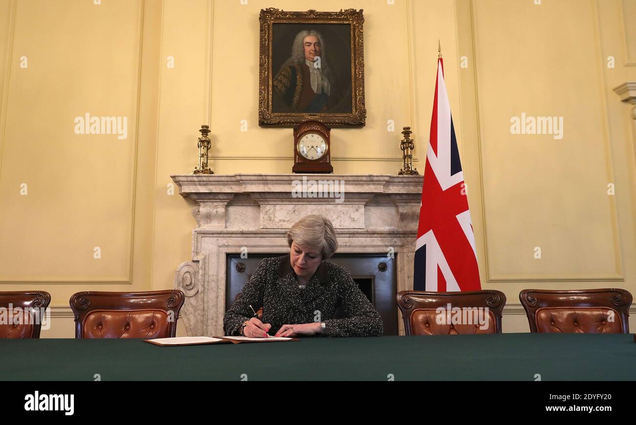 File photo dated 28/03/17 of Prime Minister Theresa May in the cabinet signing the Article 50 letter, preparing to trigger the start of the UK's formal withdrawal from the EU on Wednesday. The UK and EU have reached a post-Brexit trade agreement. Stock Photo