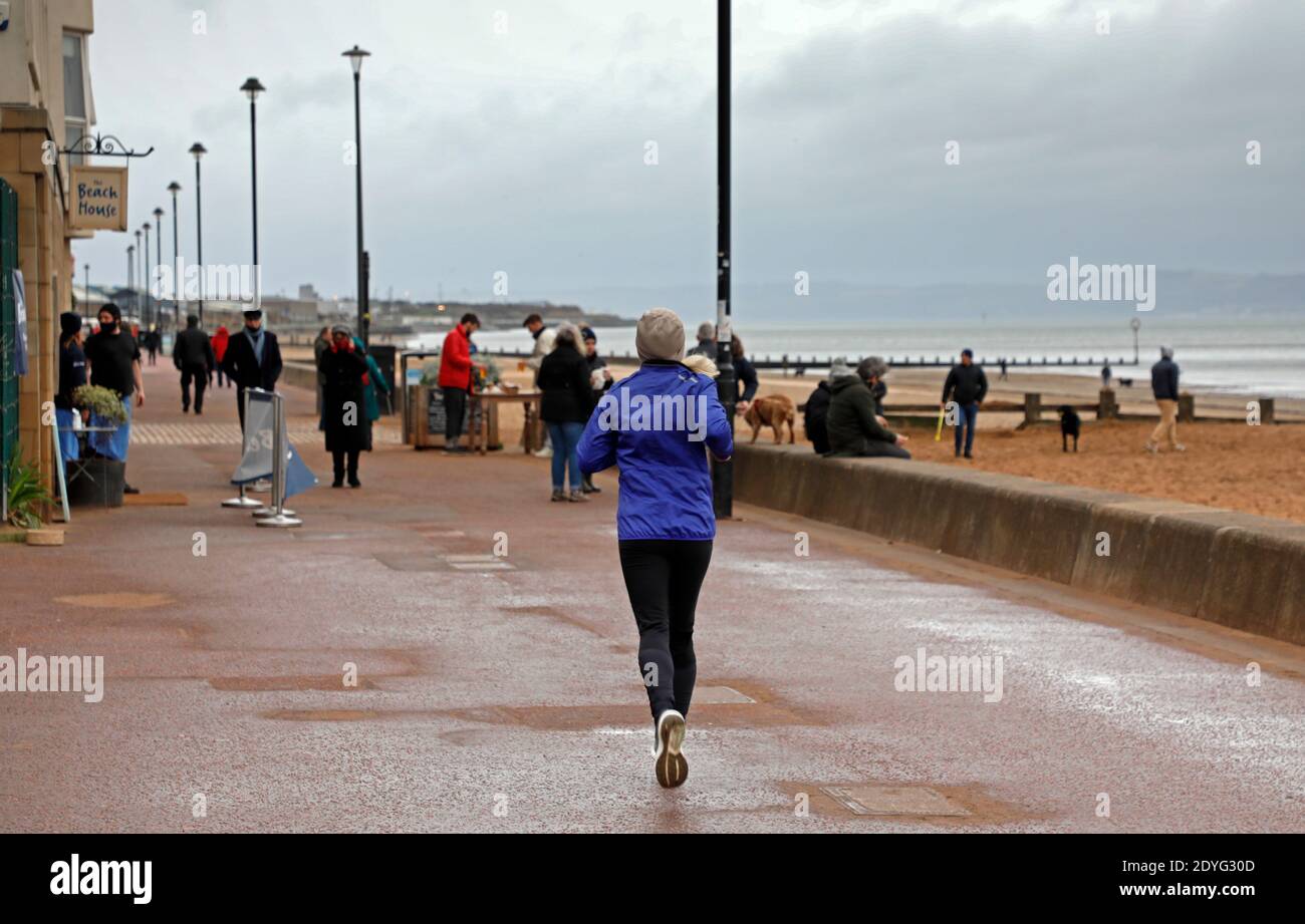 Portobello, Edinburgh, Scotland, UK. 26 December 2020. Exercising outdoors  was recommended this morning on BBC by Prof. Devi Sridhar, pictured: people  out exercising at the seaside even though it is cold on