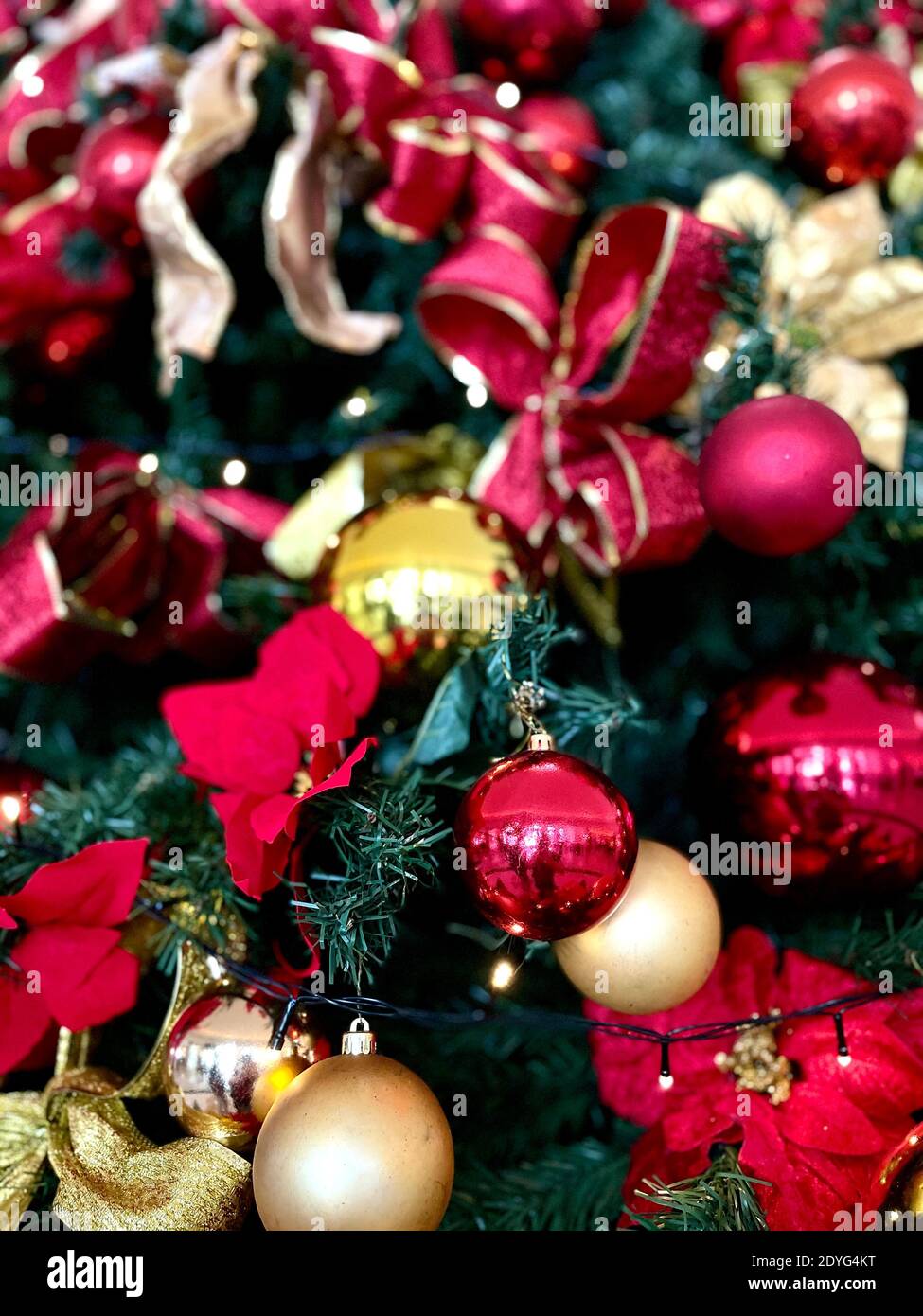 Interior well decorated Christmas tree. Magic glowing tree, fireplace